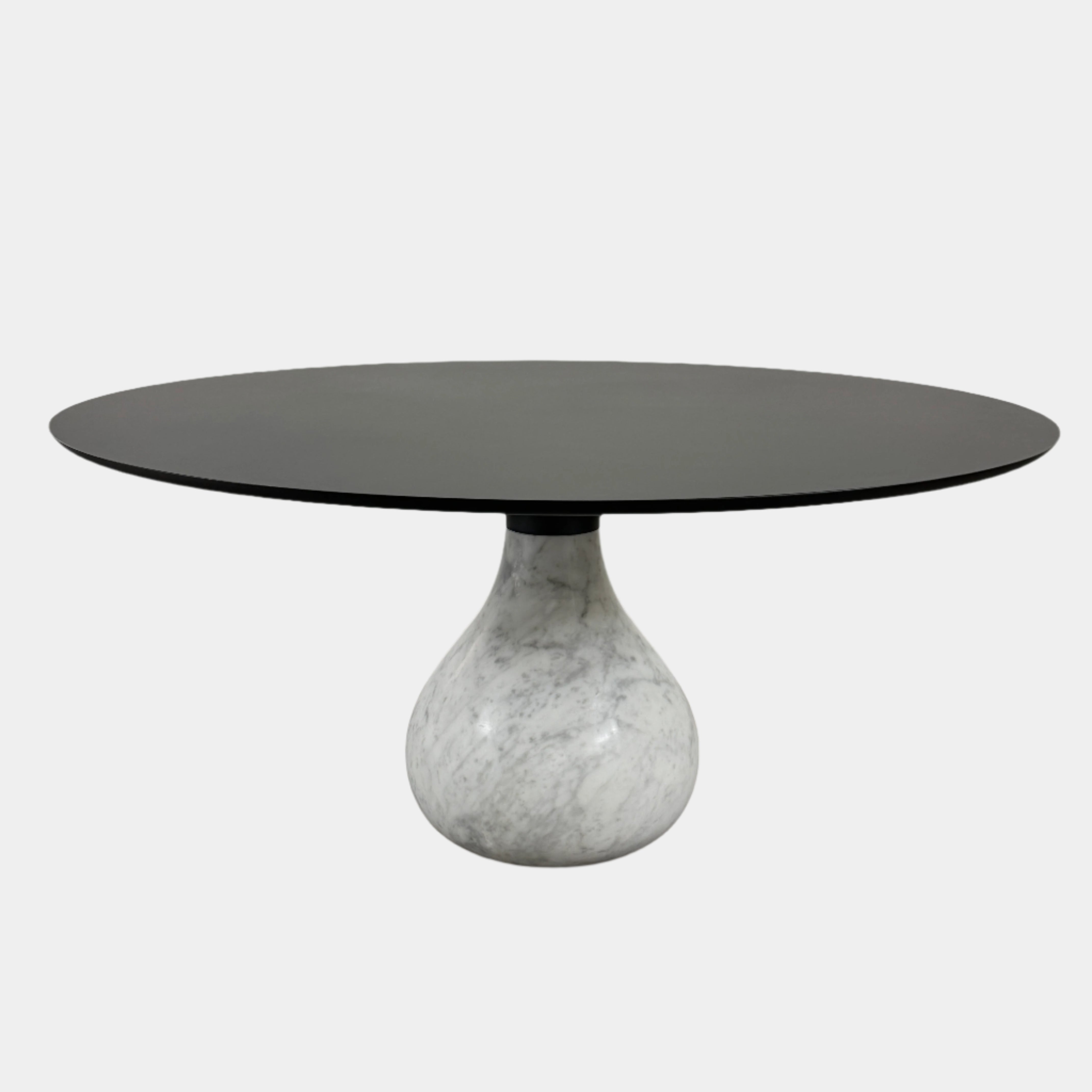 The Roche Bobois Aqua Round Table features a sleek black top and a teardrop-shaped white marble base, blending elegance and modern style—an iconic design by Roche Bobois, shown here against a plain white background.