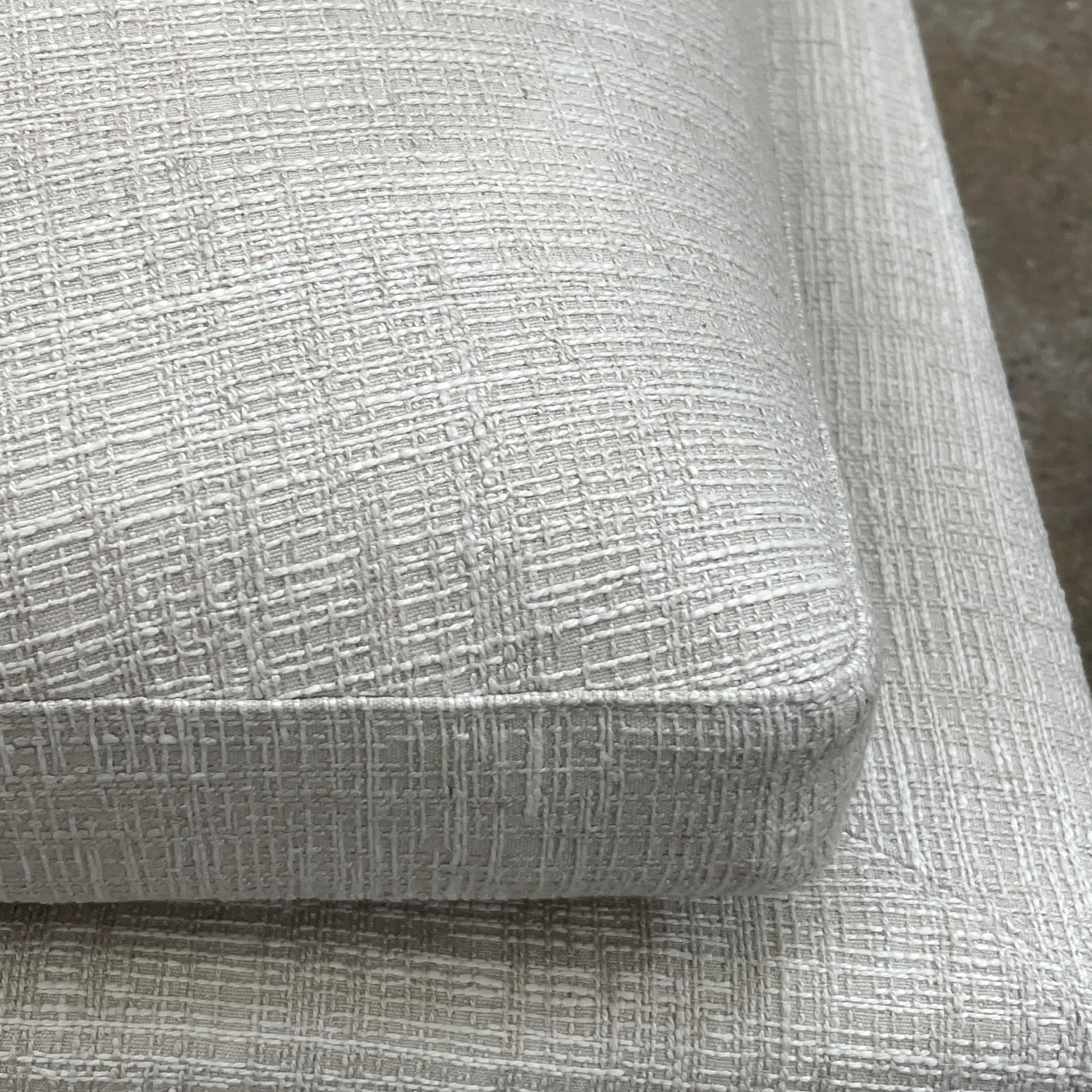 Experience the B&B Italia Arne Sofa, a modern off-white masterpiece with five plush cushions and cylindrical armrests. Designed by Antonio Citterio, it features sleek metal legs set against a crisp background.