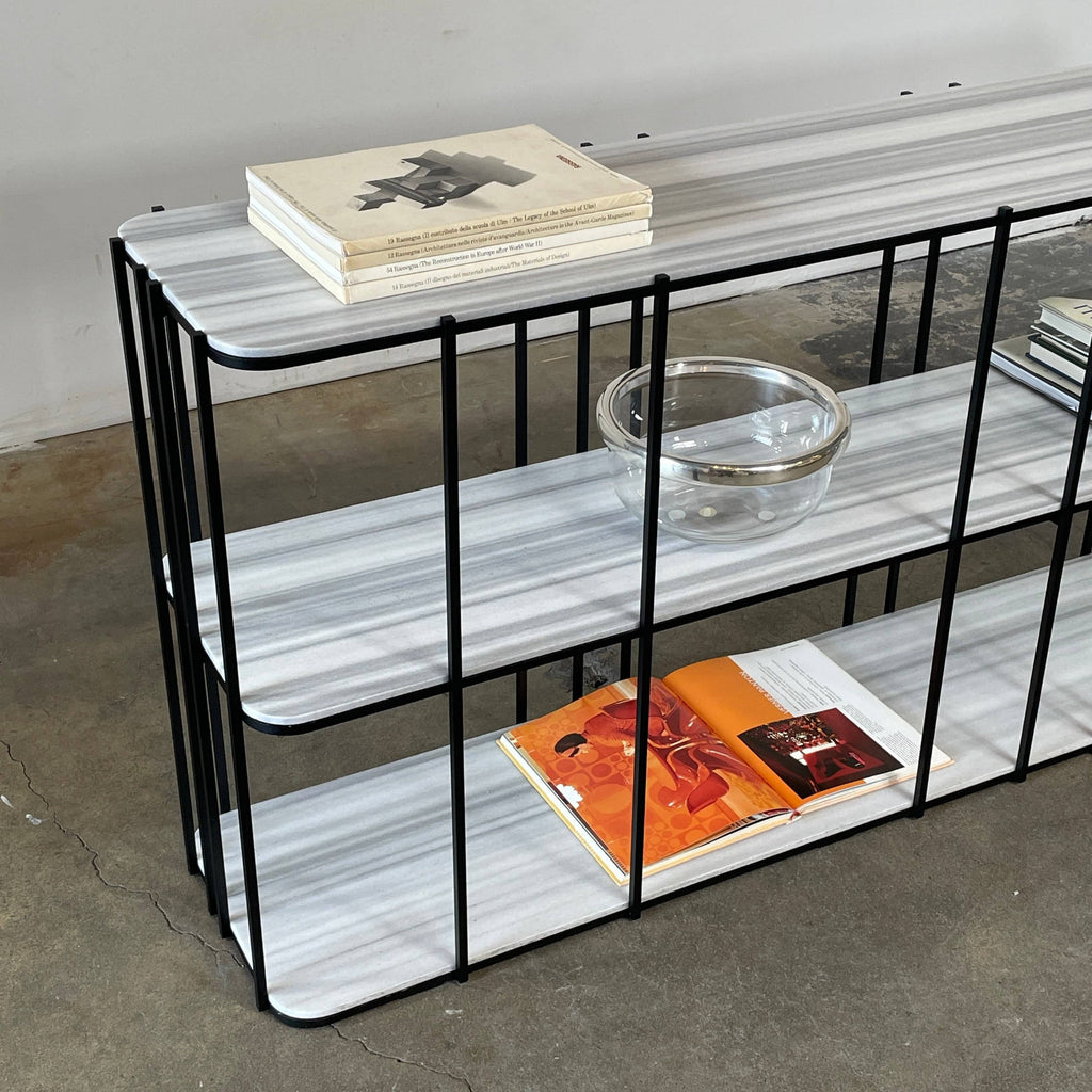 A modern luxury Delcourt Collection ATO Bookcase black and white shelf with shelves on it, showcasing sustainable practices.