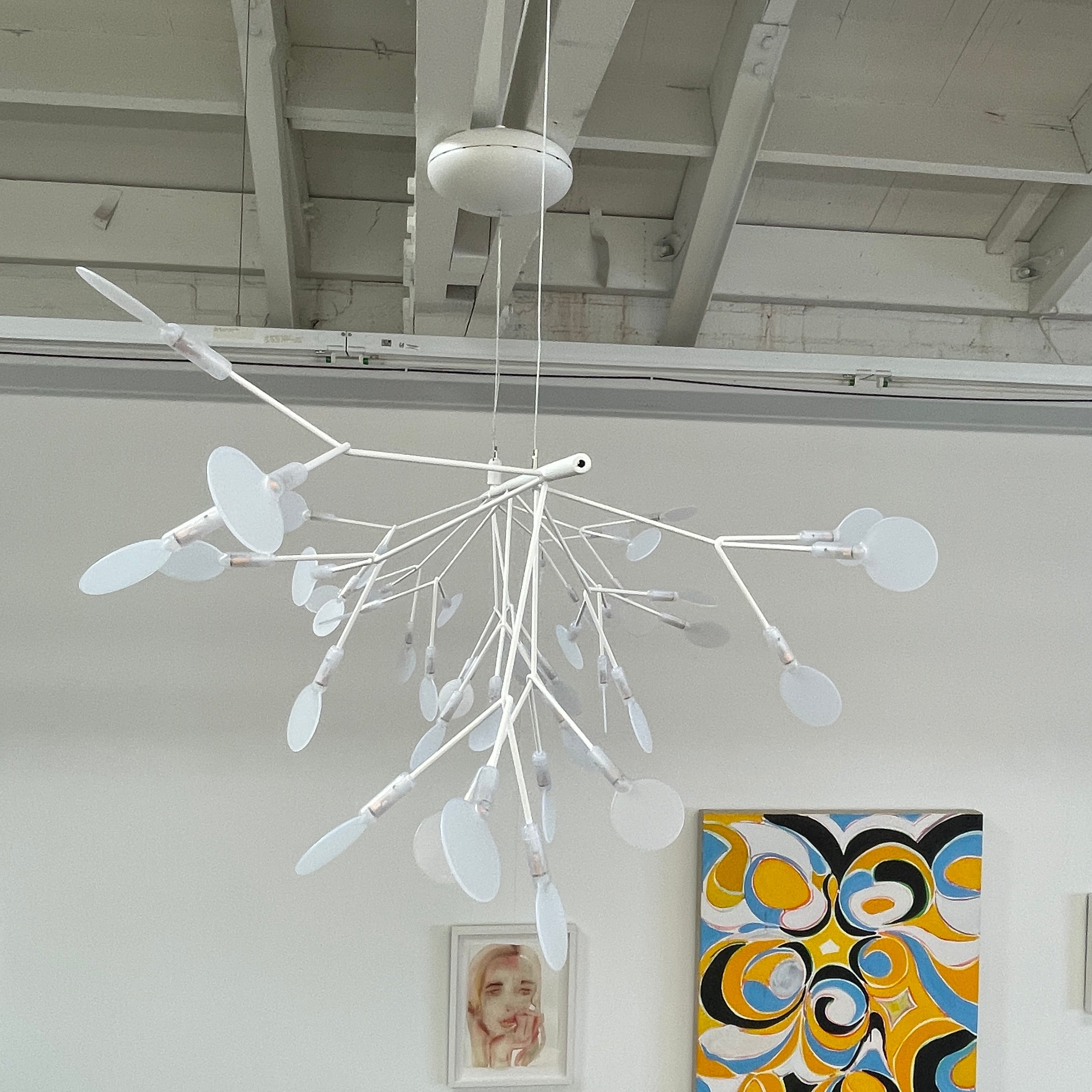 The Moooi Heracleum Endless LED Suspension Lamp-White is a modern chandelier featuring multiple radial branches ending in circular light diffusers, hanging from a single cord attached to a round ceiling mount.