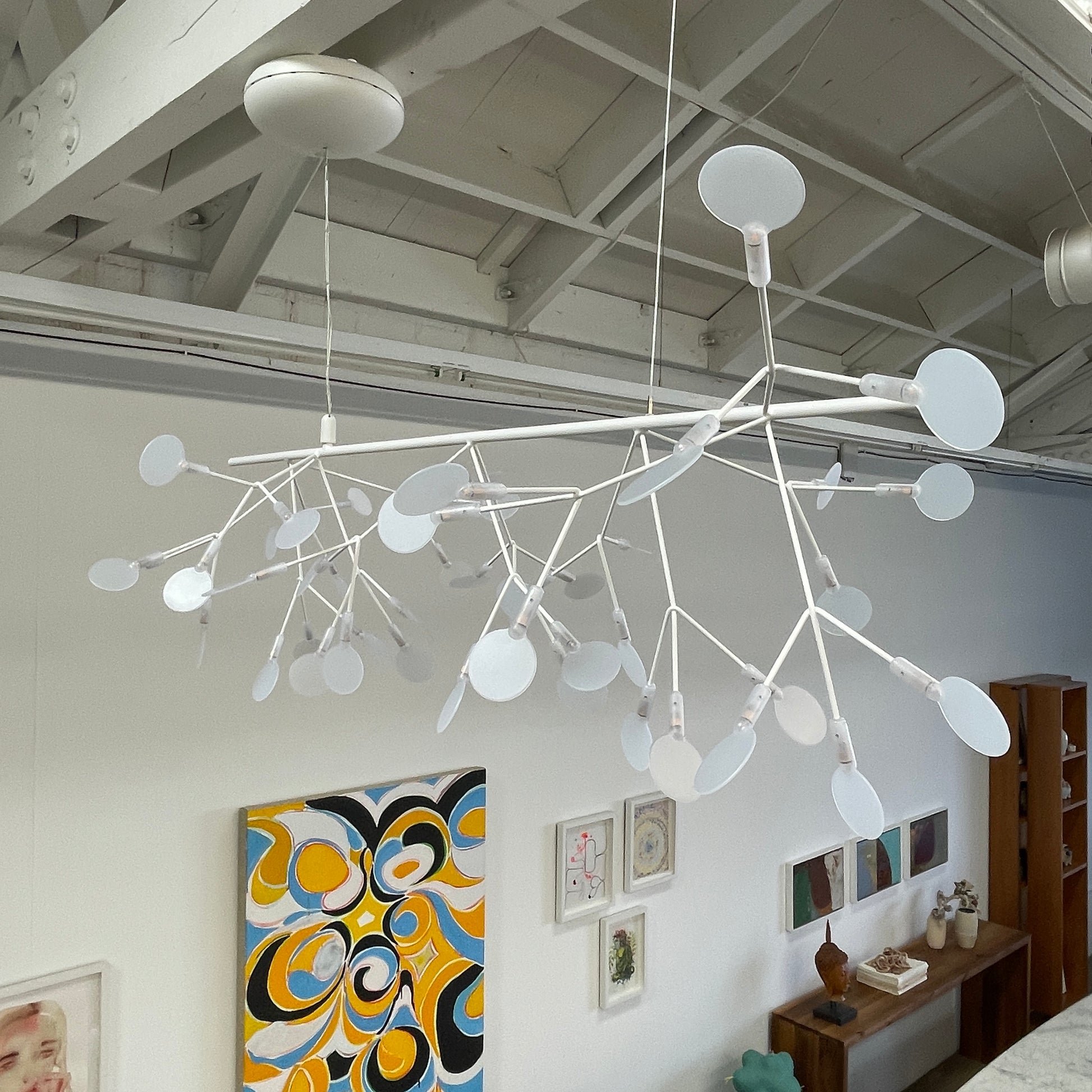 The Moooi Heracleum Endless LED Suspension Lamp-White is a modern chandelier featuring multiple radial branches ending in circular light diffusers, hanging from a single cord attached to a round ceiling mount.