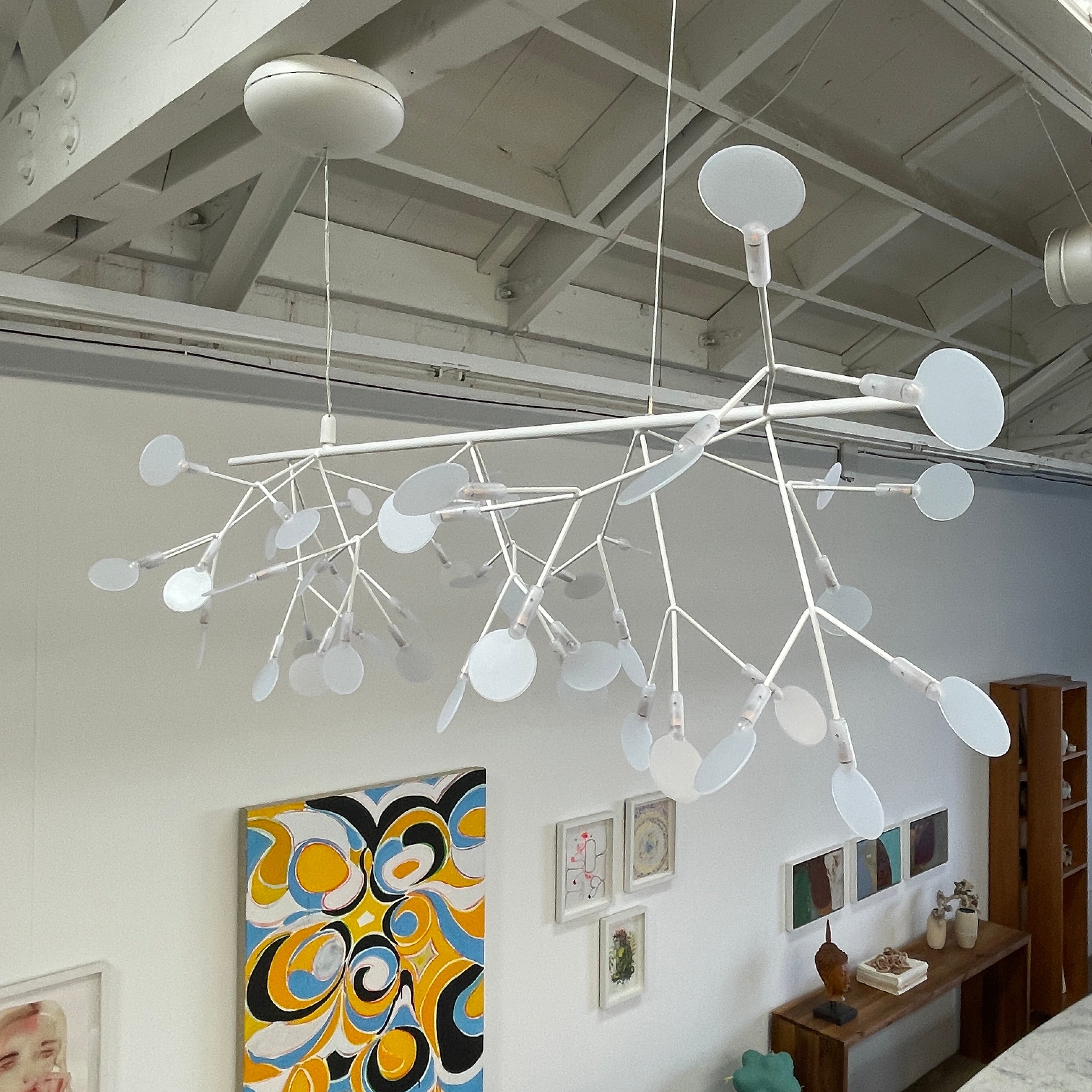The Moooi Heracleum Endless LED Suspension Lamp-White is a modern chandelier featuring multiple radial branches ending in circular light diffusers, hanging from a single cord attached to a round ceiling mount.