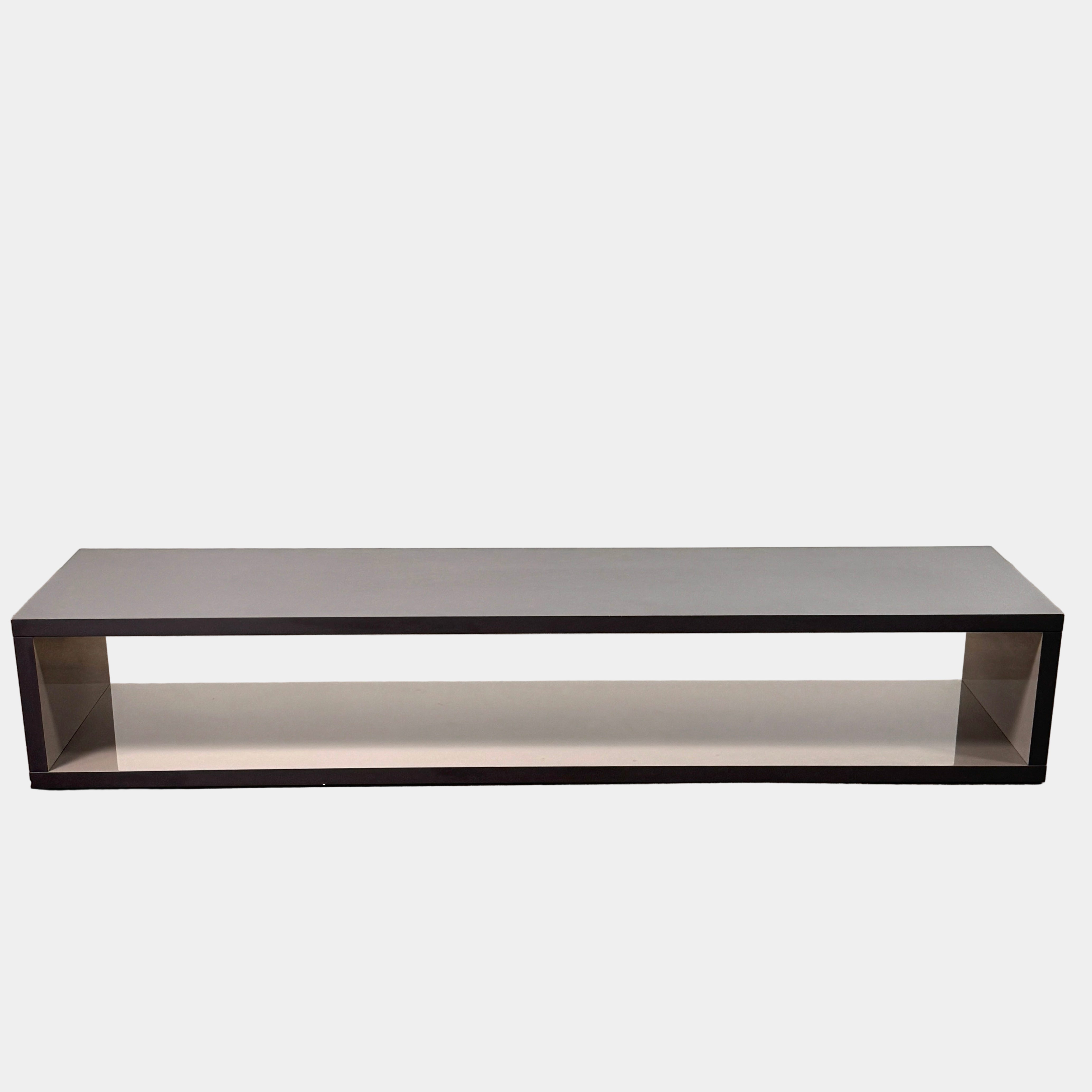 The B&B Italia Frank Low Console by B&B Italia features a sleek black rectangular frame with clear glass, making it an ideal modern low sofa back table inspired by contemporary elegance.