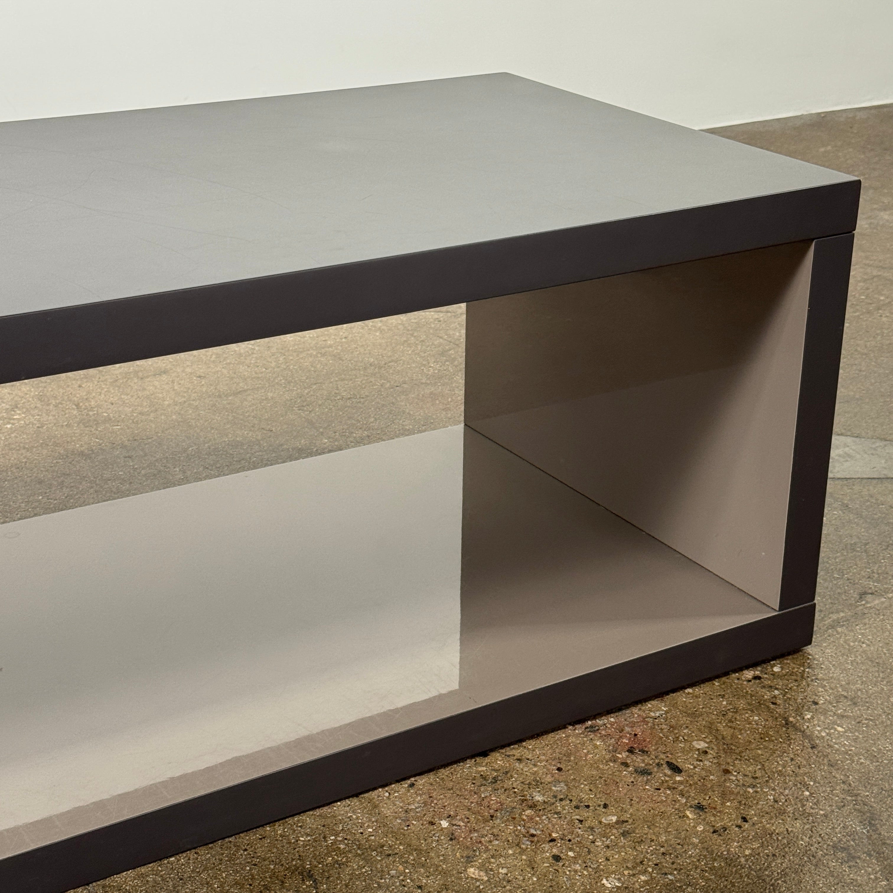 The B&B Italia Frank Low Console by B&B Italia features a sleek black rectangular frame with clear glass, making it an ideal modern low sofa back table inspired by contemporary elegance.