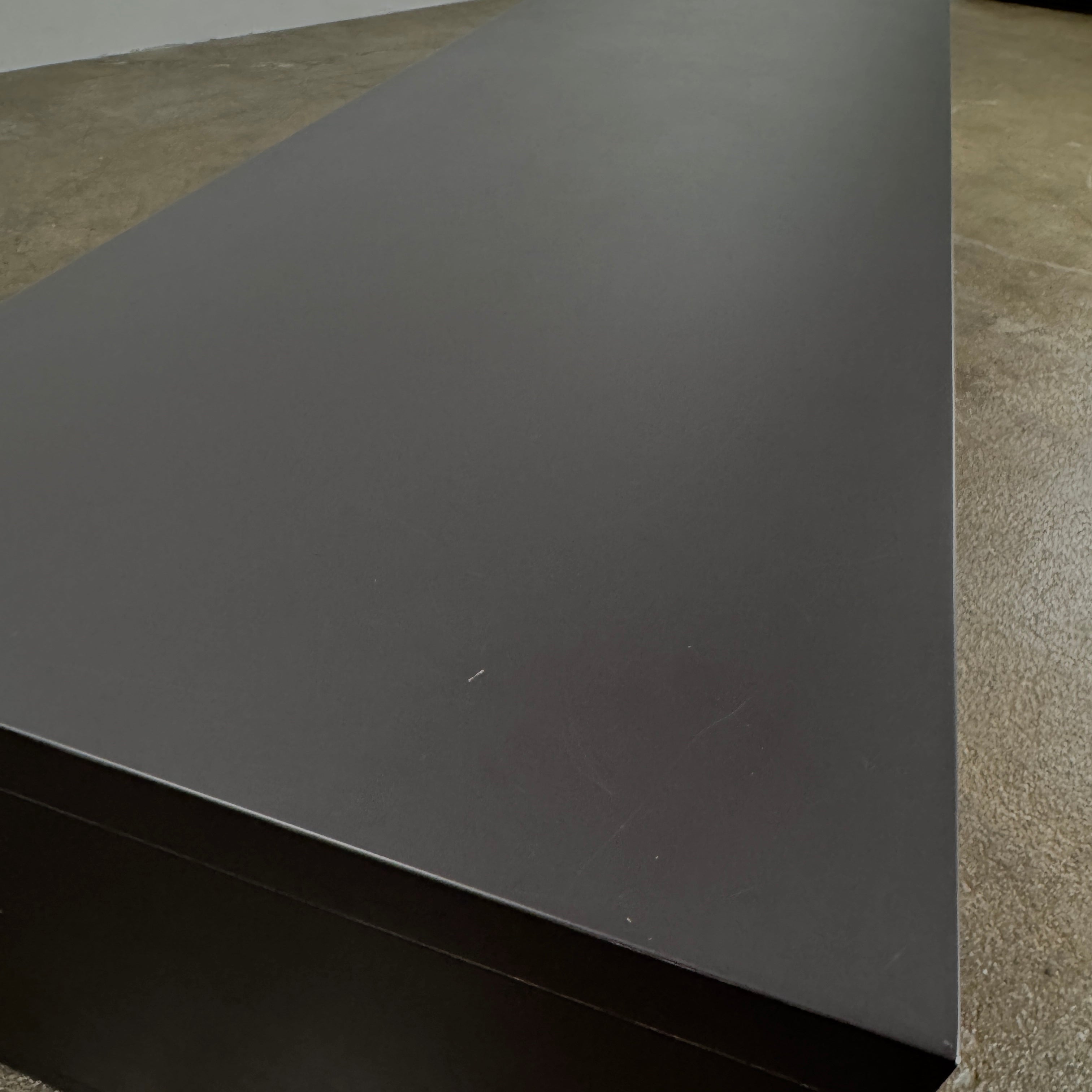 The B&B Italia Frank Low Console by B&B Italia features a sleek black rectangular frame with clear glass, making it an ideal modern low sofa back table inspired by contemporary elegance.