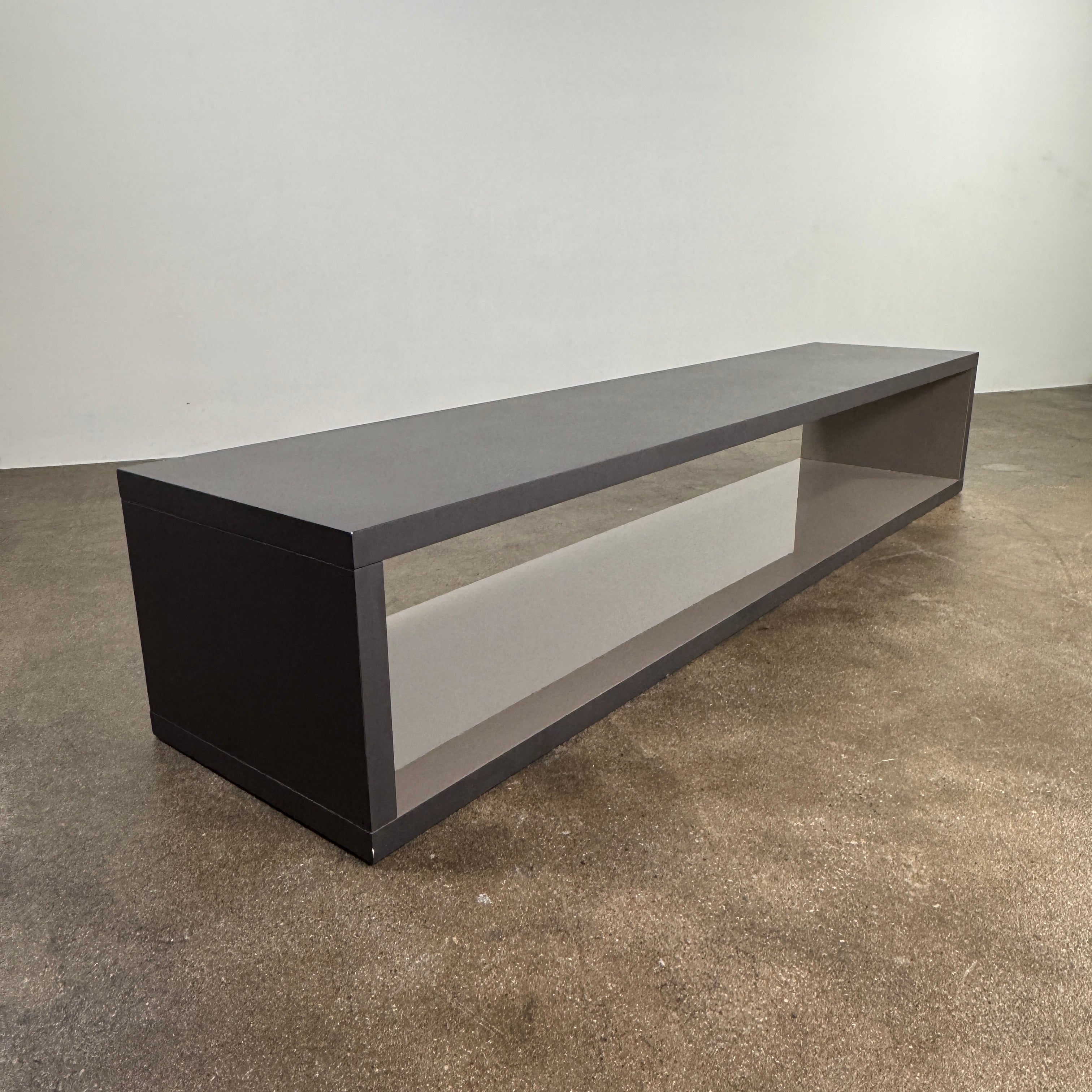 The B&B Italia Frank Low Console by B&B Italia features a sleek black rectangular frame with clear glass, making it an ideal modern low sofa back table inspired by contemporary elegance.