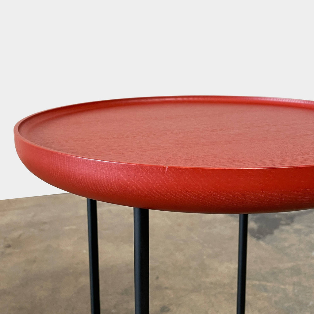 The Cassina Cassina Torei Side Table combines elegance and versatility with its red top and black base.