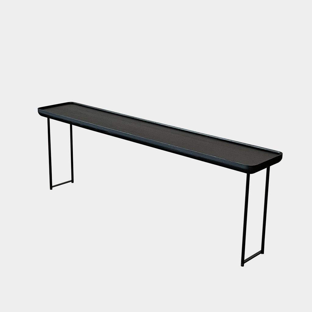 A sleek Cassina Torei Side Table with modern metal legs.