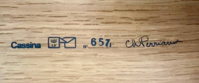 Modern Cassina Ventaglio Table inspired by Charlotte Perriand's functional ingenuity, with an asymmetrical, angular top and four cylindrical legs, isolated on a white background.