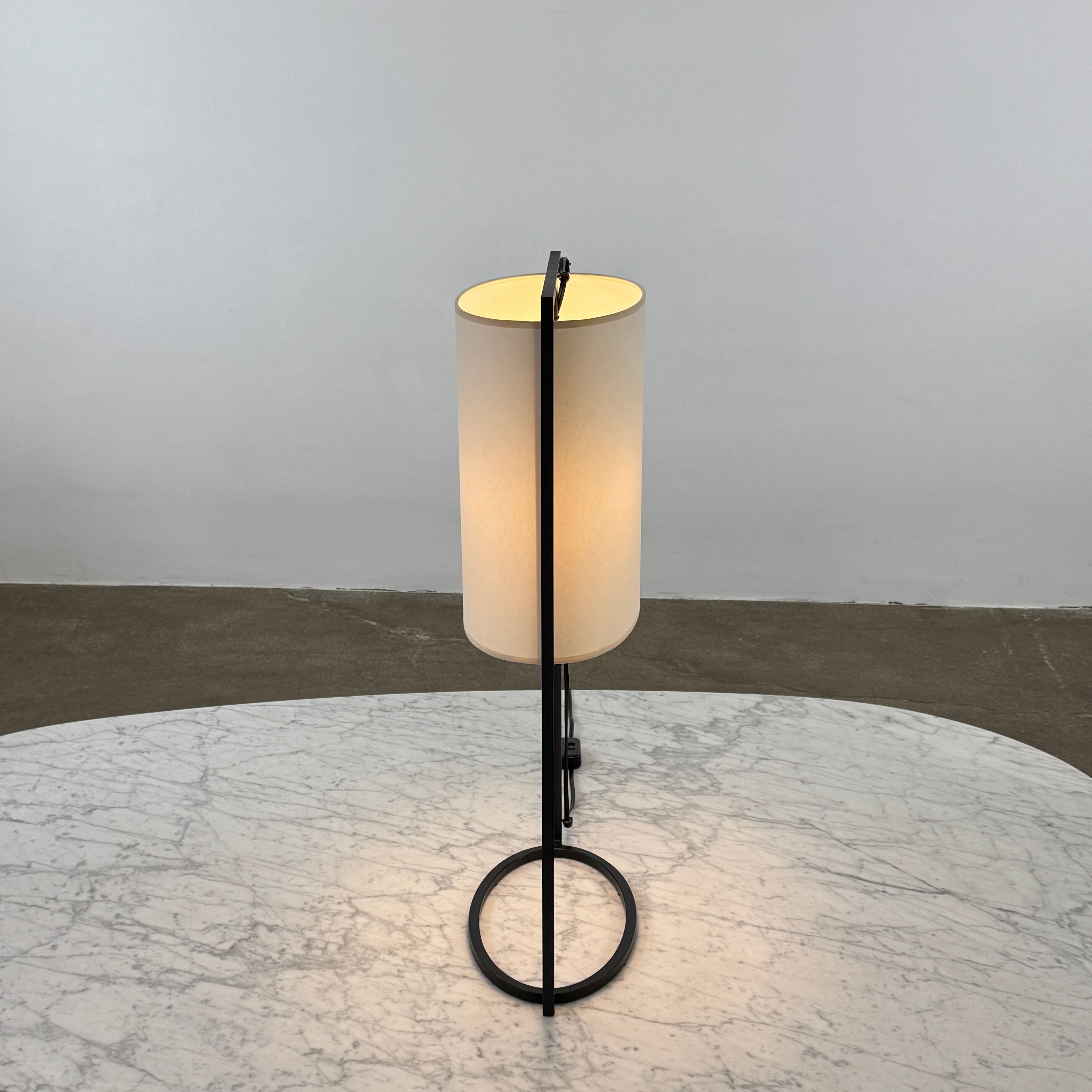 The Holly Hunt Pattern Table Lamp by Holly Hunt features a white cylindrical shade and black metal frame, offering modern style and dimmable lighting—perfect as a stylish reading lamp on any white background.