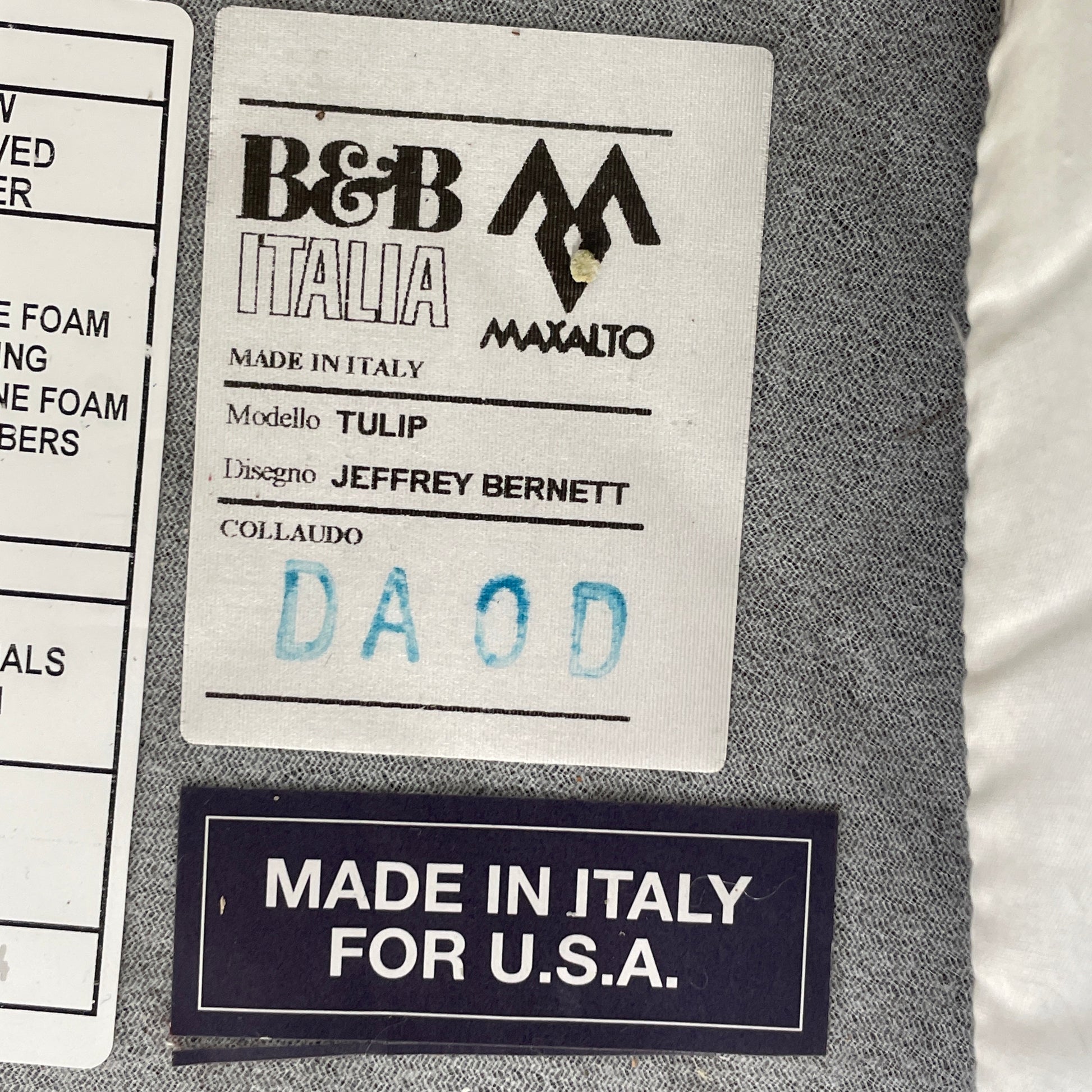 The B&B Italia Tulip Swivel Armchair by B&B Italia features a modern orange design with a curved backrest, seat cushion, and metal swivel base, shown against a plain white background.