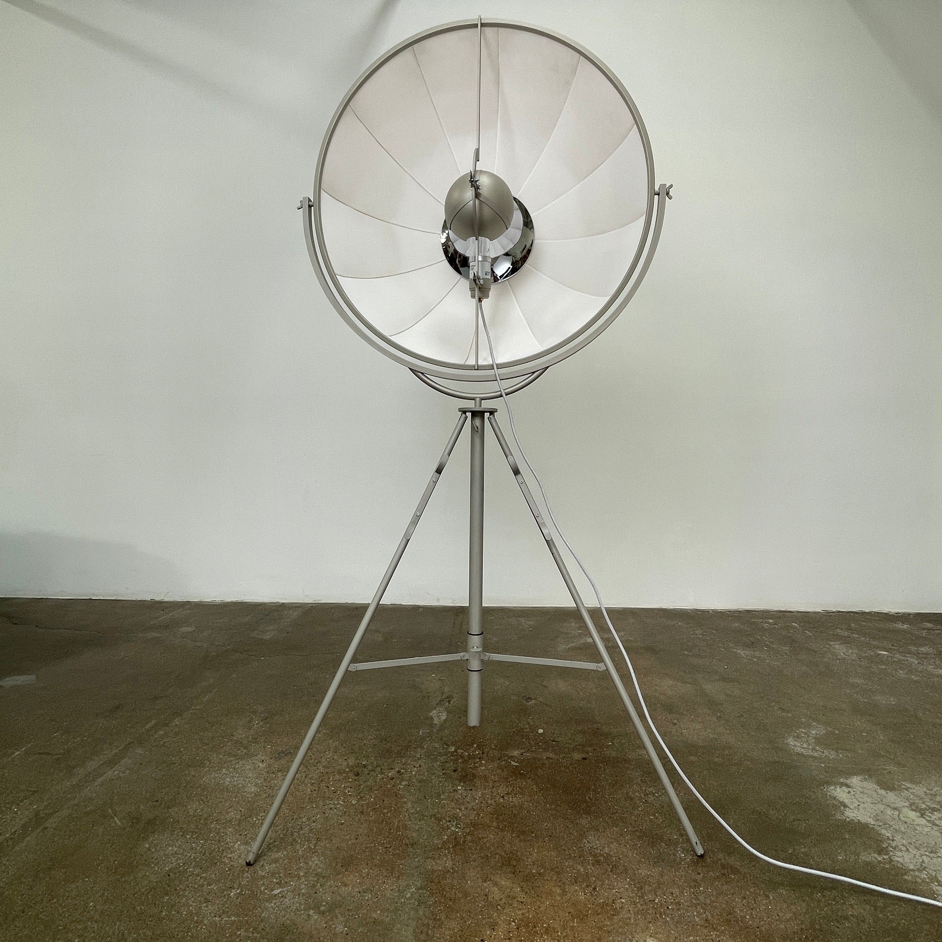 The Pallucco Italia Fortuny Ornament Floor Lamp, with its visible bulb and patterned spherical shade, gracefully stands on a plain white background, epitomizing the elegance of Pallucco Italia.