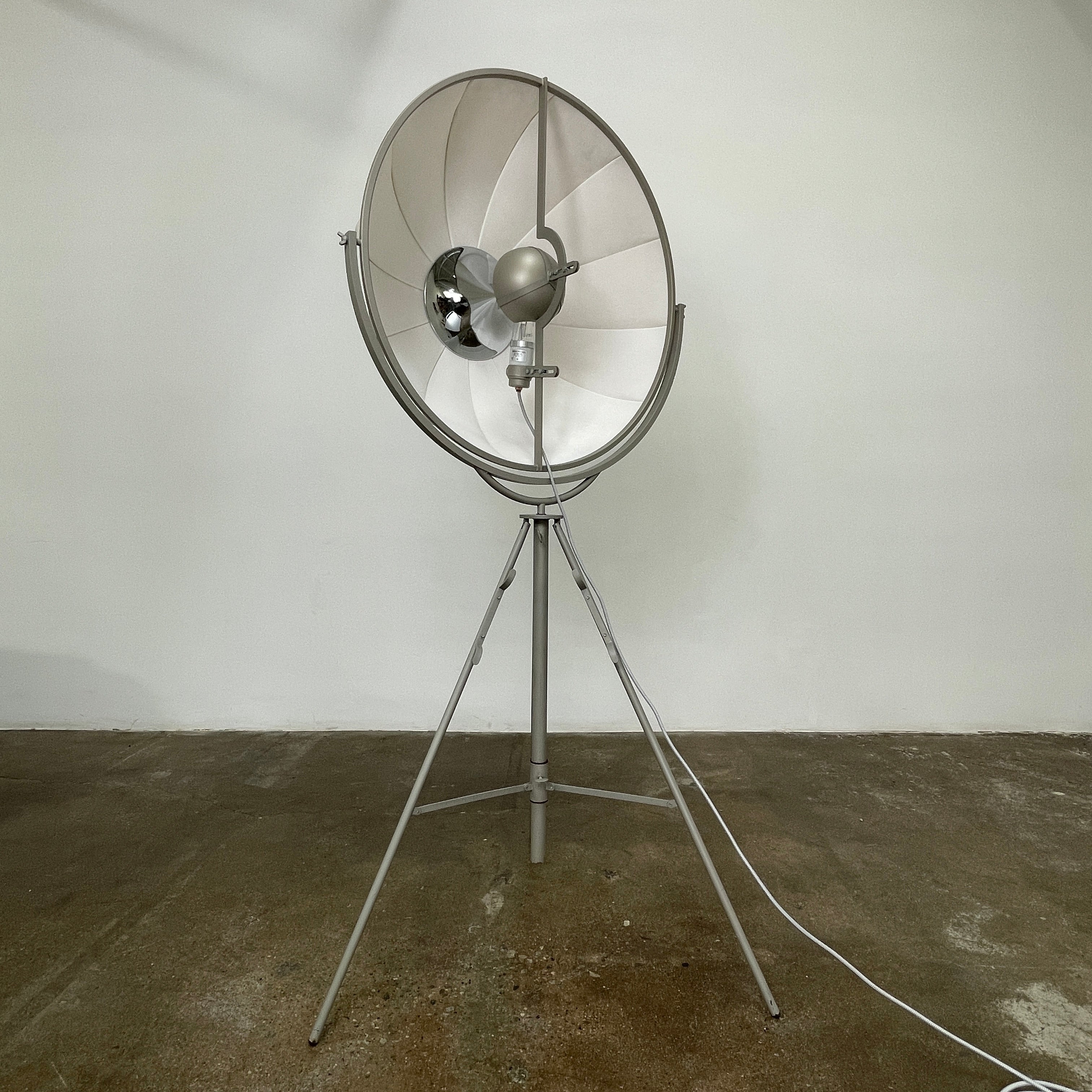 The Pallucco Italia Fortuny Ornament Floor Lamp, with its visible bulb and patterned spherical shade, gracefully stands on a plain white background, epitomizing the elegance of Pallucco Italia.