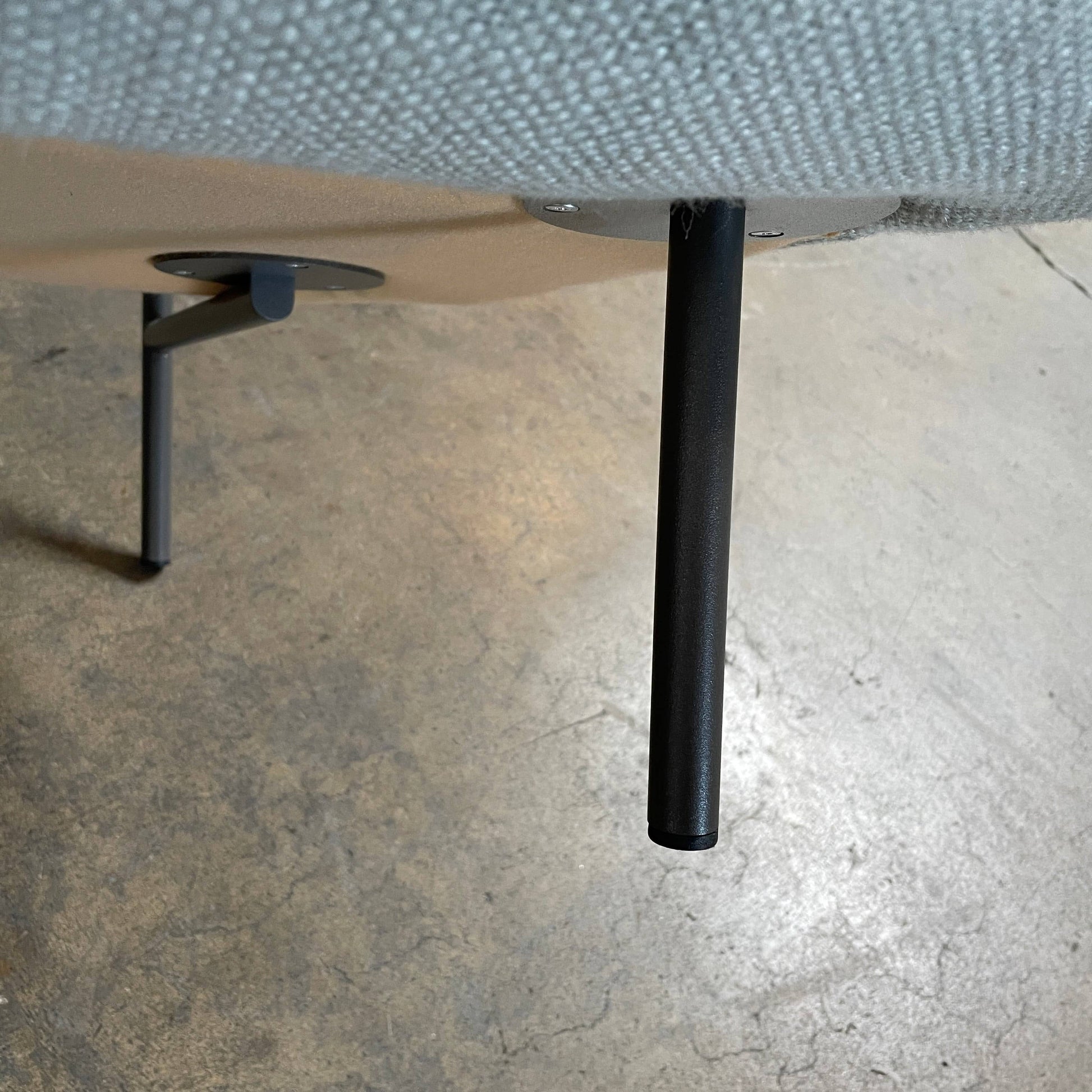 The Delcourt Collection Hug Armchair, upholstered in a delightful light blue fabric, features sleek black legs.