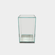 A clear rectangular glass display case with a metal base, inspired by the Cassina Volage side table Philippe Starck from Cassina, shown against a plain white background.