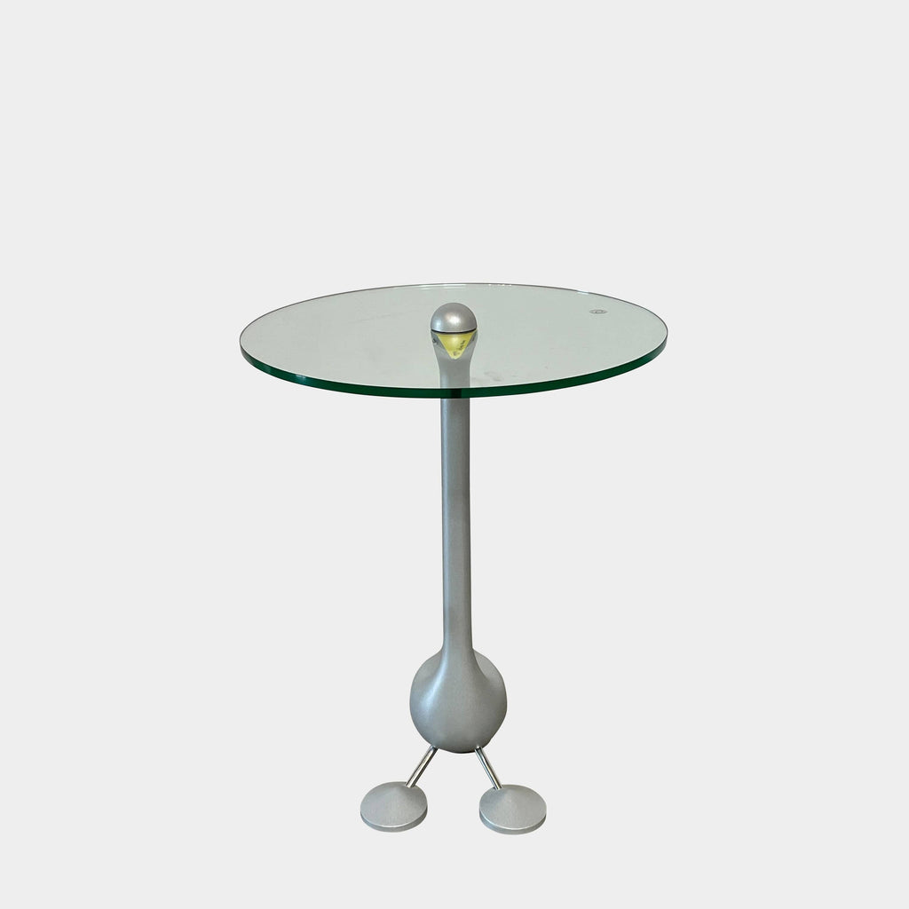 The Zanotta Edizioni Sirfo "Goose" table, designed by Alessandro Mendini, features a stunning glass top with a whimsical bird perched on it.