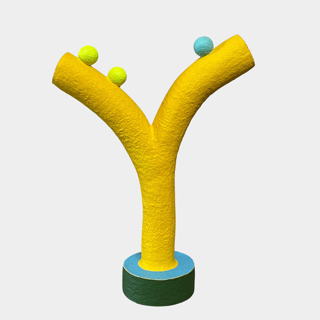 A yellow Gemel Sculpture No.99 with a blue ball in the middle created by Terri Chiao and Adam Frezza as part of their CHIAOZZA Gemel Sculpture series.