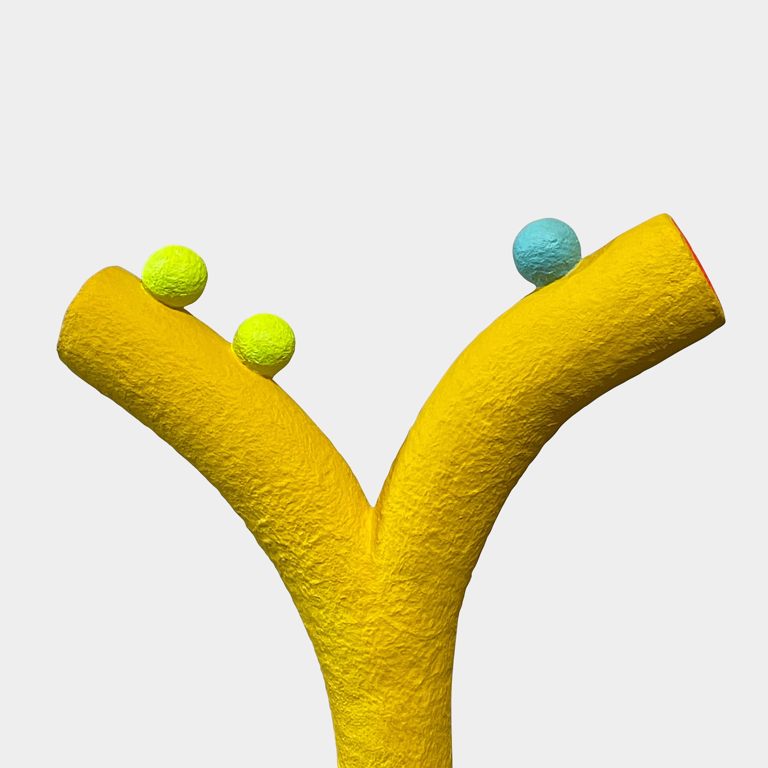 A yellow Gemel Sculpture No.99 with a blue ball in the middle created by Terri Chiao and Adam Frezza as part of their CHIAOZZA Gemel Sculpture series.