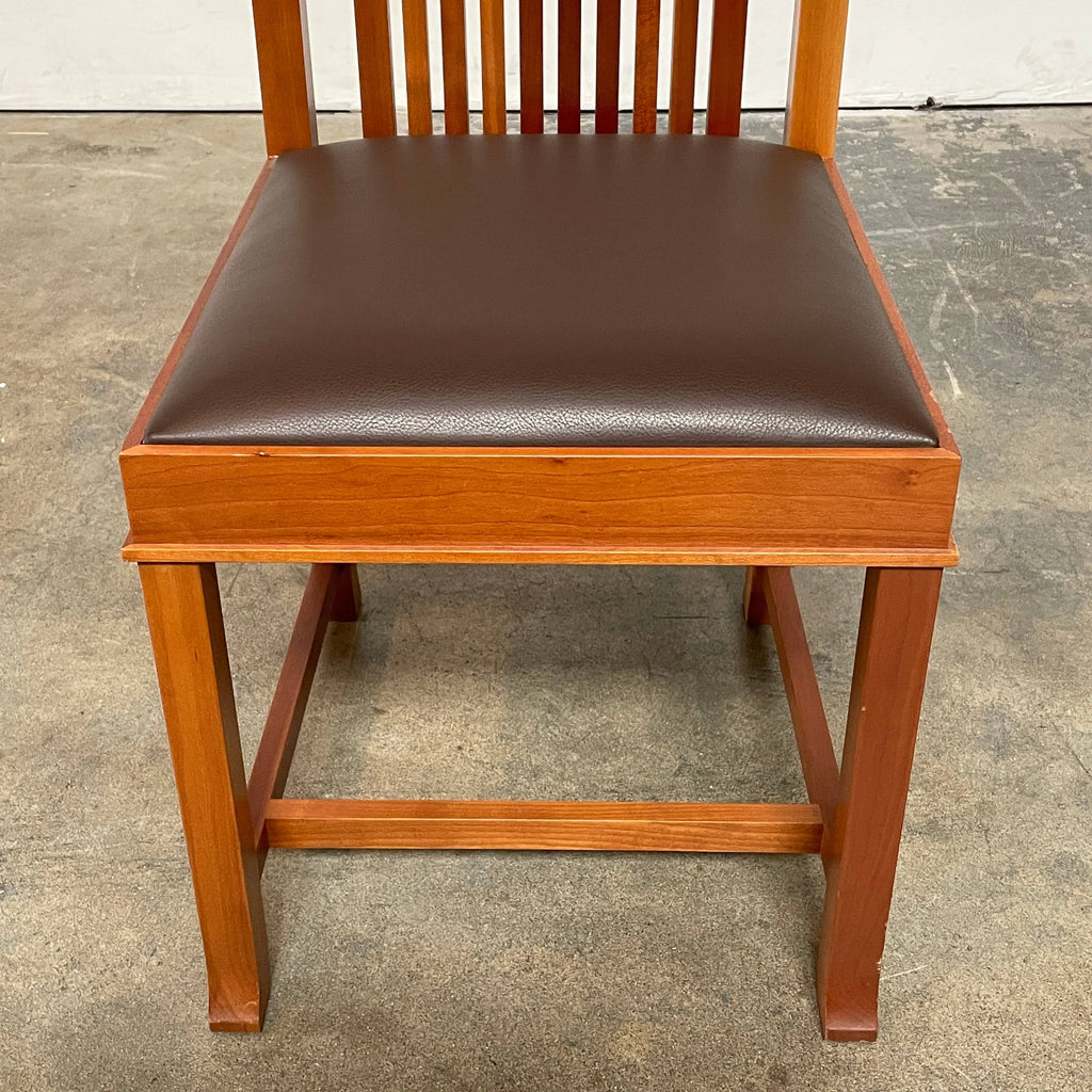 A Cassina Coonley Dining Chair with a leather seat.