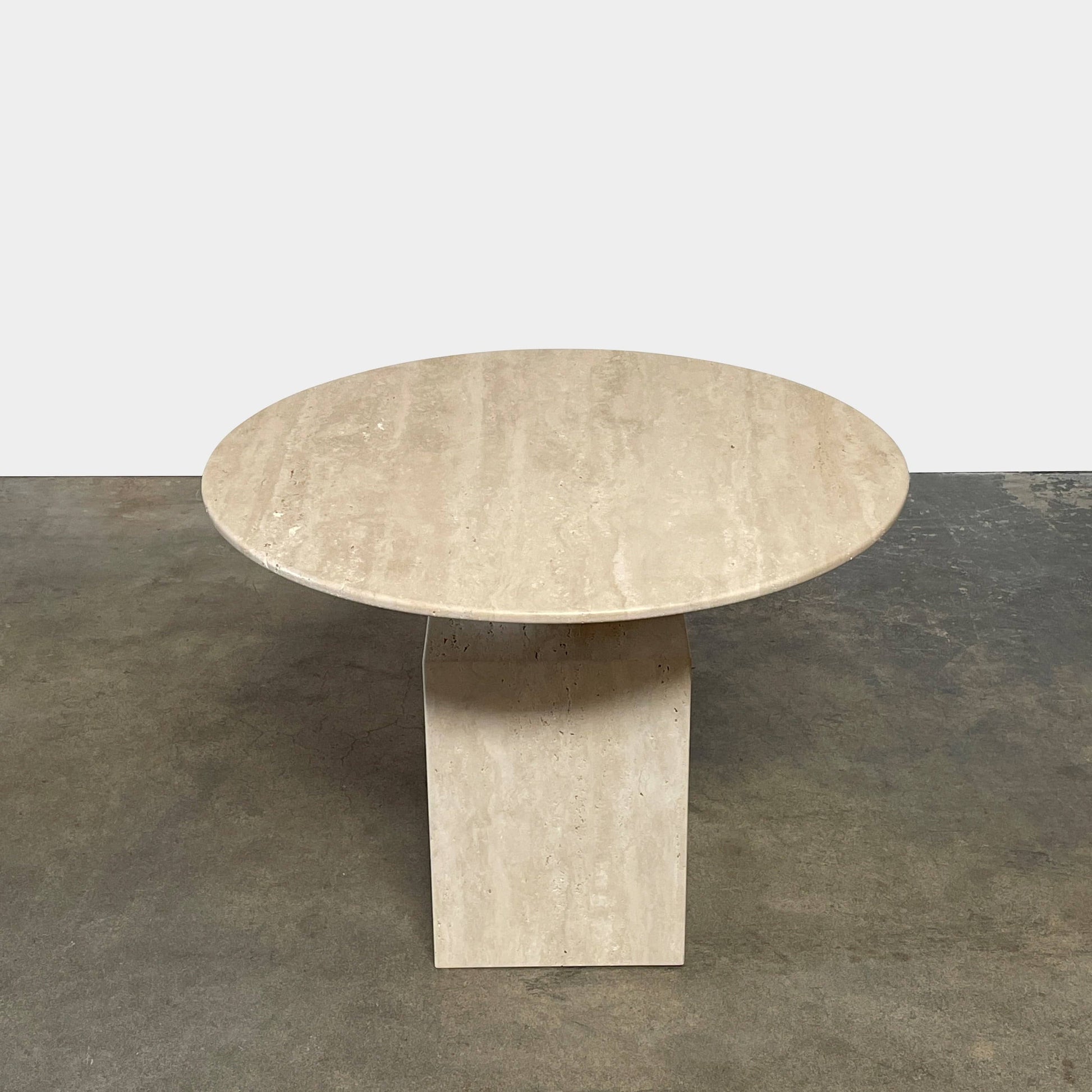 A Delcourt Collection Ouk Sylver Travertine Table, handcrafted and imported from France, is displayed on a white background.
