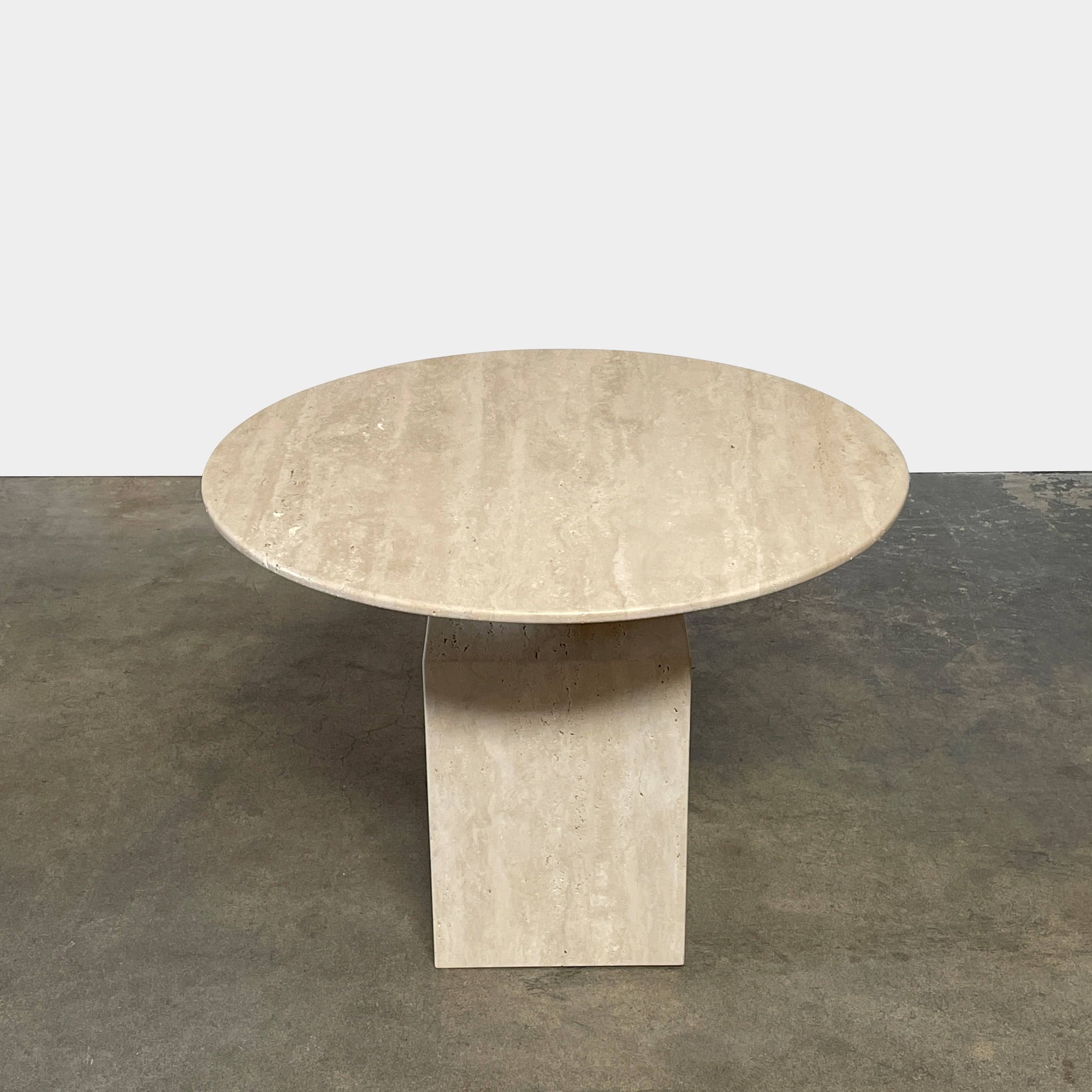 A Delcourt Collection Ouk Sylver Travertine Table, handcrafted and imported from France, is displayed on a white background.
