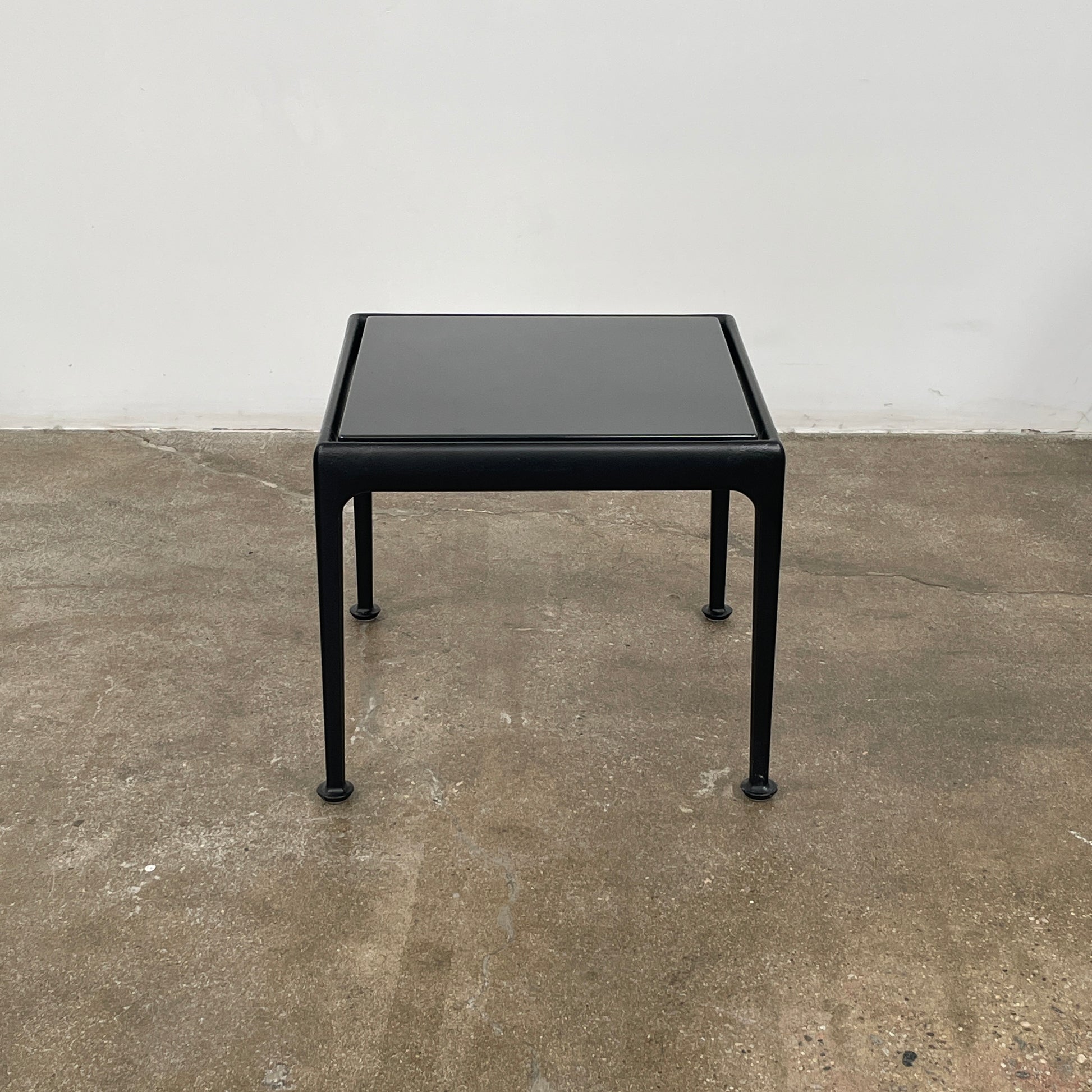 The Knoll 1966 Outdoor End Table in Onyx features four straight legs with rounded feet and a weather-resistant finish, making it ideal for outdoor living. Shown against a plain white background.