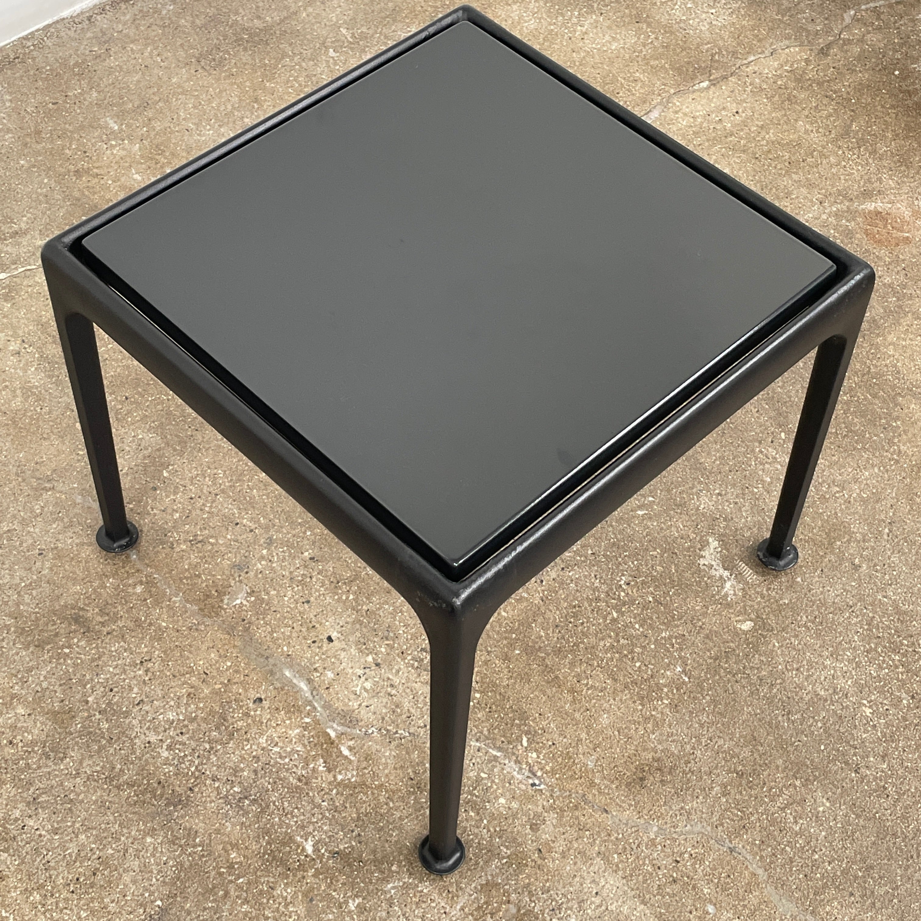 The Knoll 1966 Outdoor End Table in Onyx features four straight legs with rounded feet and a weather-resistant finish, making it ideal for outdoor living. Shown against a plain white background.