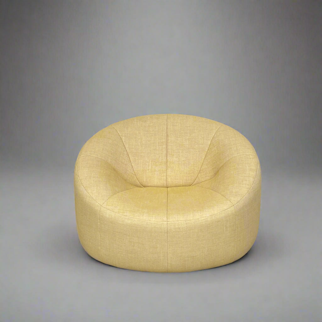 A light yellow Ligne Roset Pumpkin Swivel Lounge Chair with a round shape, low back, and wide seat is shown against a plain white background.