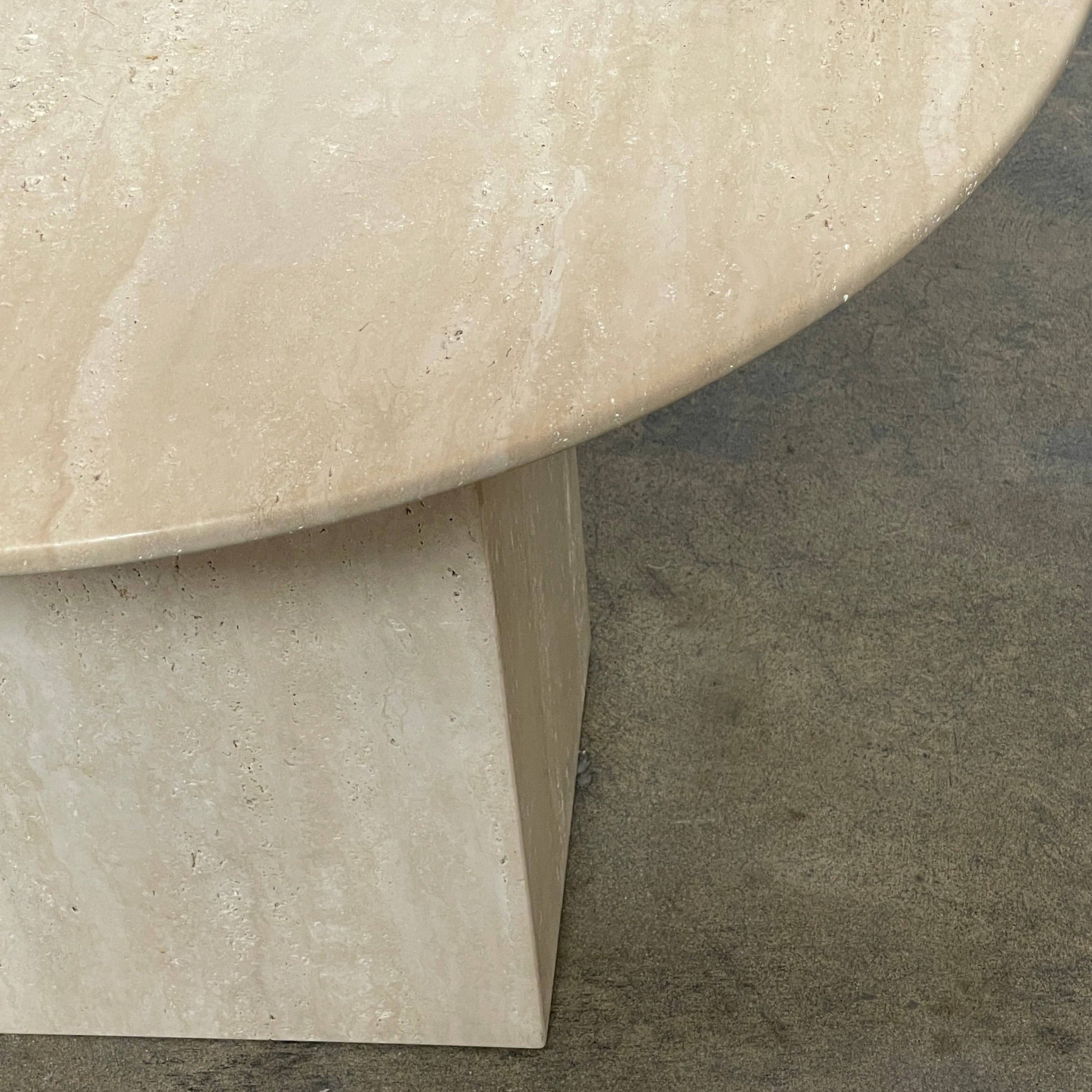 A Delcourt Collection Ouk Sylver Travertine Table, handcrafted and imported from France, is displayed on a white background.