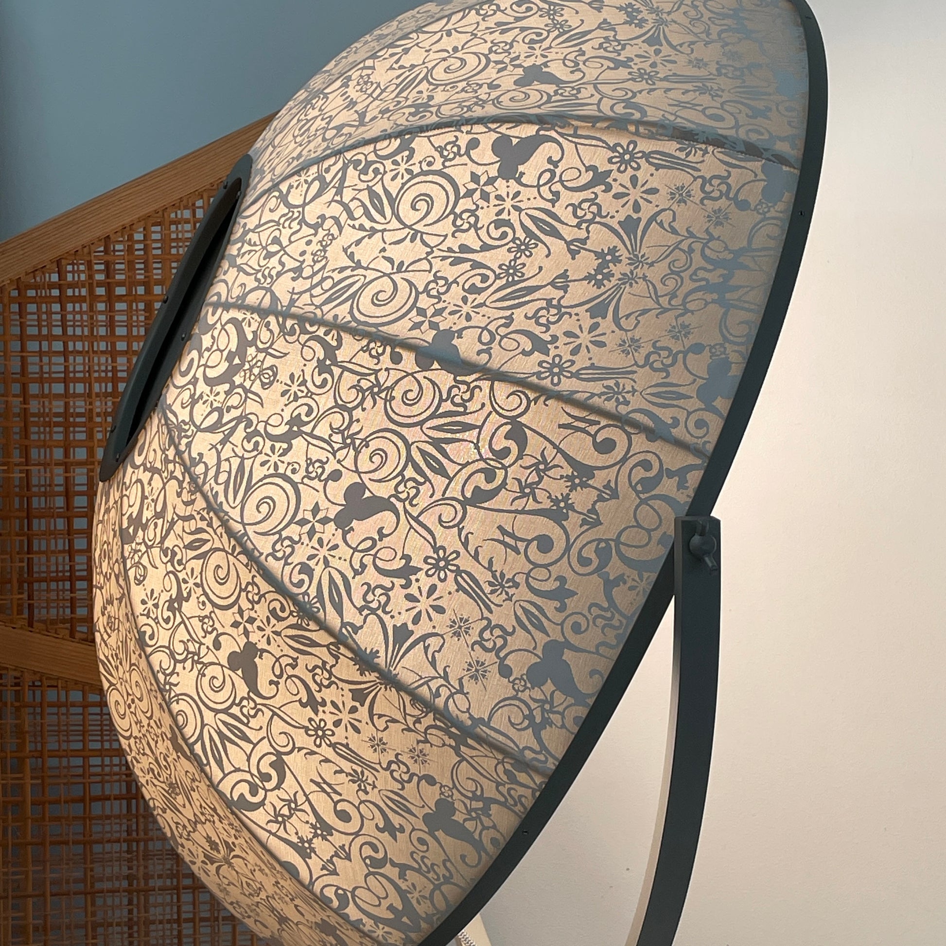 The Pallucco Italia Fortuny Ornament Floor Lamp, with its visible bulb and patterned spherical shade, gracefully stands on a plain white background, epitomizing the elegance of Pallucco Italia.