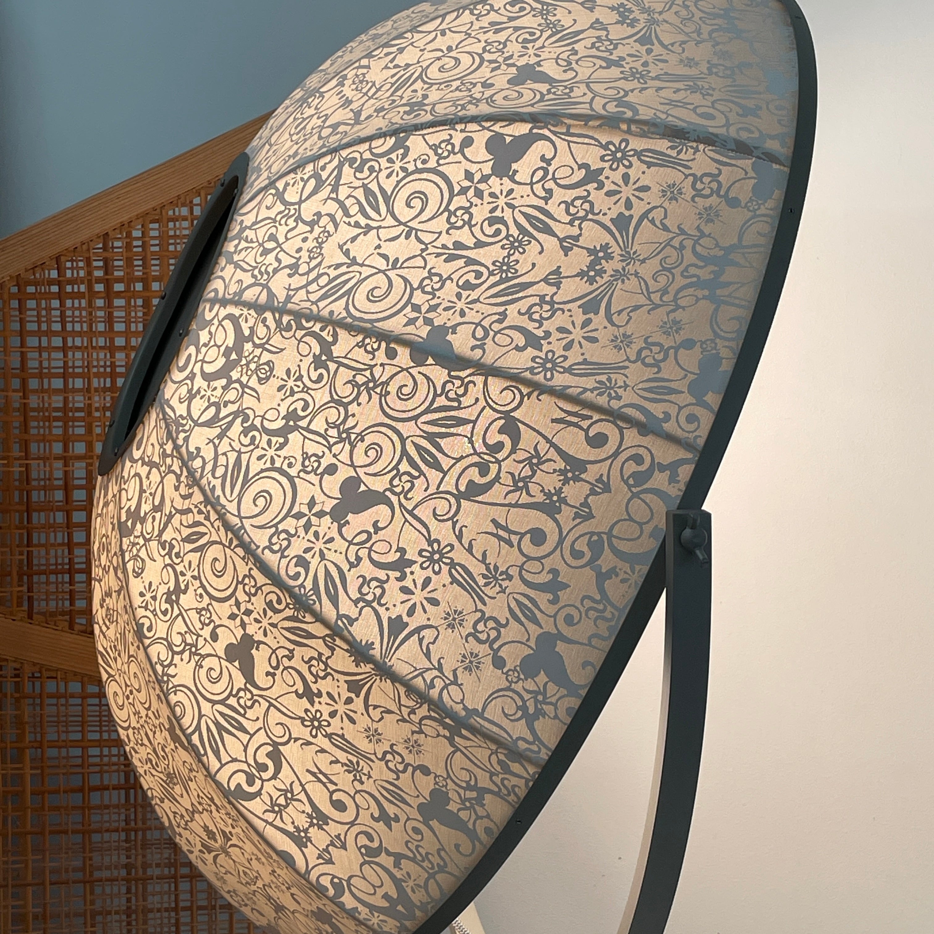 The Pallucco Italia Fortuny Ornament Floor Lamp, with its visible bulb and patterned spherical shade, gracefully stands on a plain white background, epitomizing the elegance of Pallucco Italia.