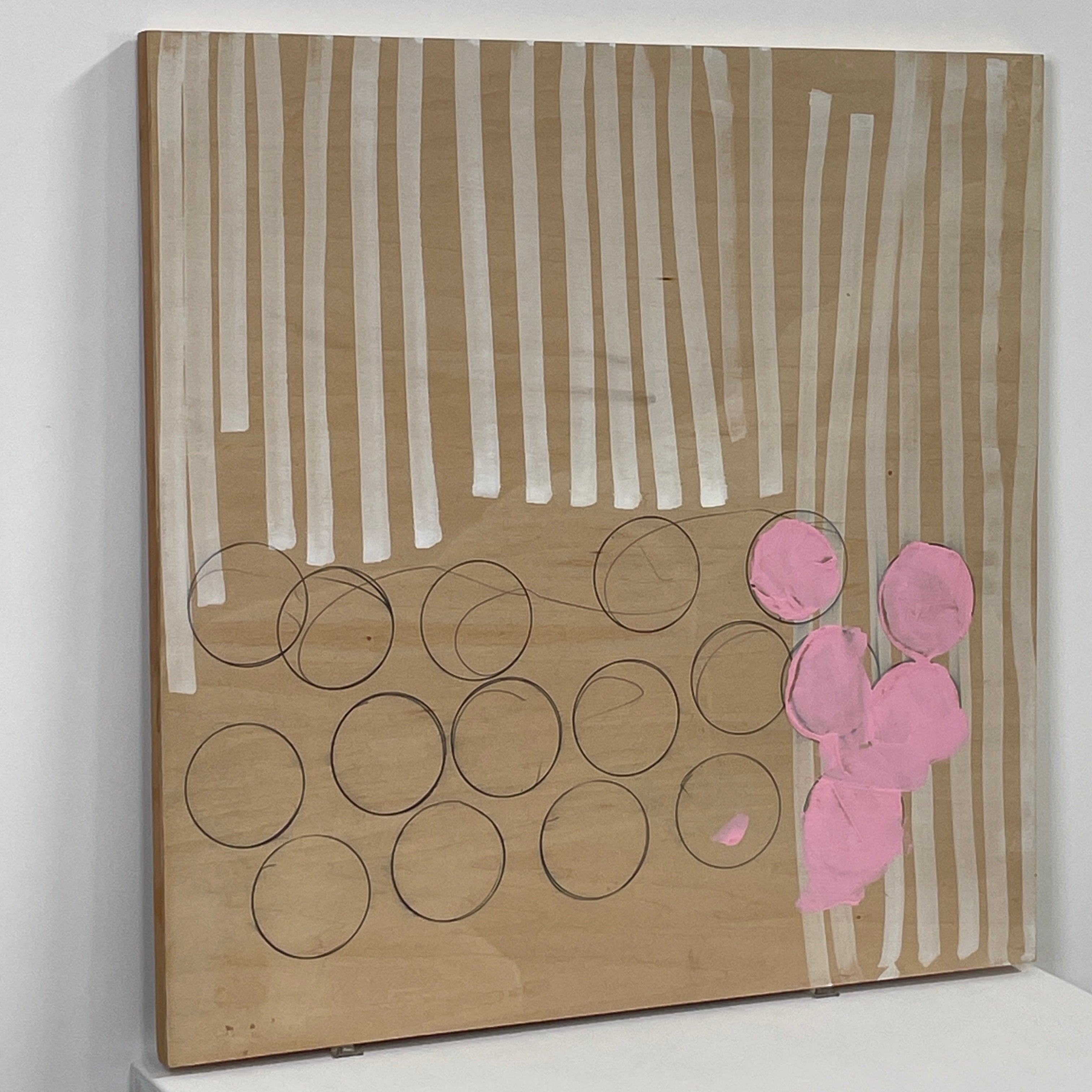 The experimental art piece "Switch" by Allison Caesar showcases vertical white lines, circular outlines, and pink patches on a wooden background.
