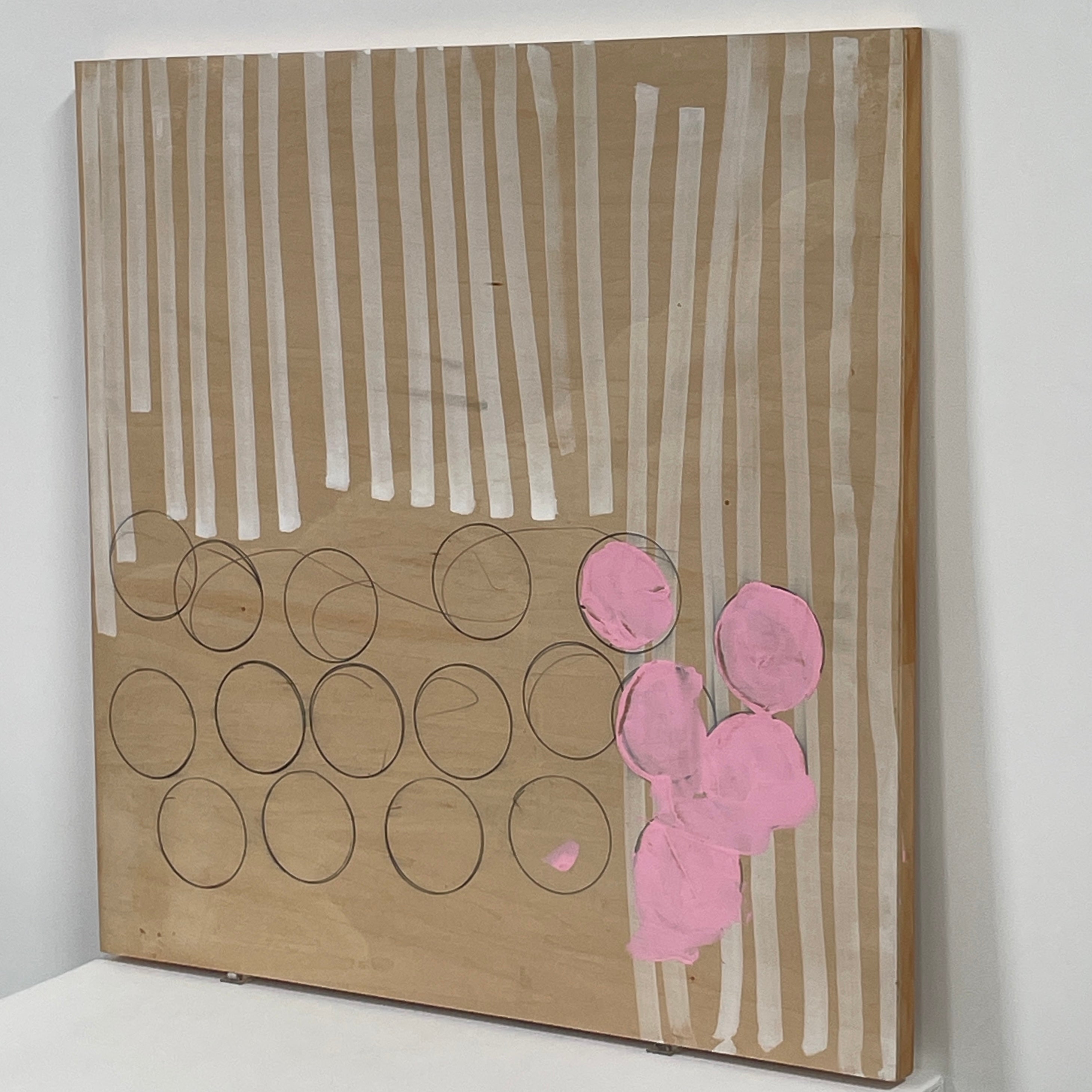 The experimental art piece "Switch" by Allison Caesar showcases vertical white lines, circular outlines, and pink patches on a wooden background.