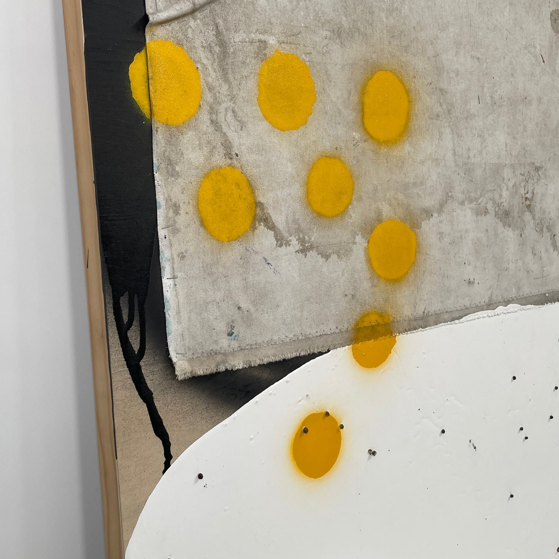 The diptych "Before We Met" by Allison Caesar displays a masterful mixed media technique: the left panel features intricately detailed gray, white, and yellow circles, while the right panel offers dynamic textures as yellow paint interacts with torn paper on a textured surface.