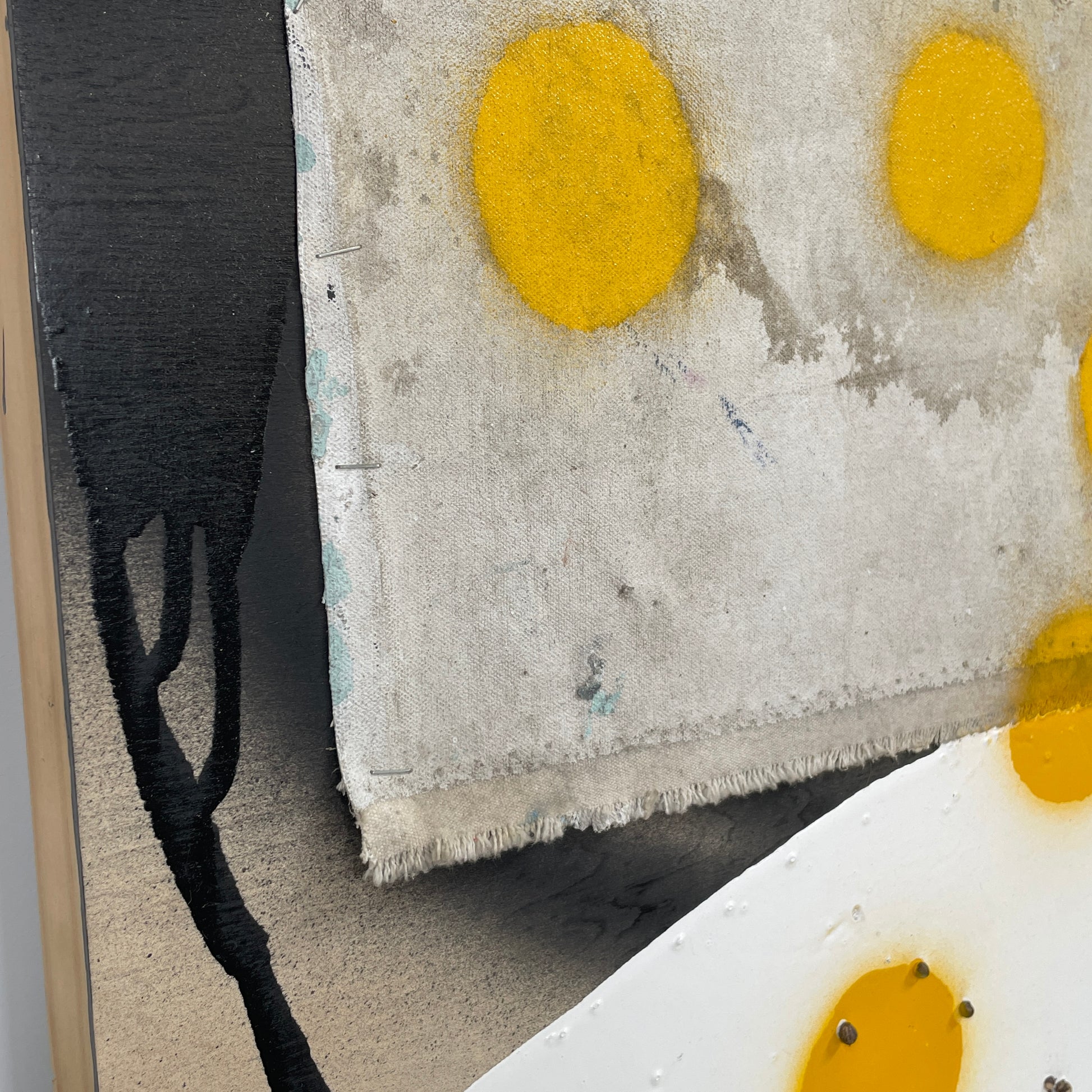 The diptych "Before We Met" by Allison Caesar displays a masterful mixed media technique: the left panel features intricately detailed gray, white, and yellow circles, while the right panel offers dynamic textures as yellow paint interacts with torn paper on a textured surface.