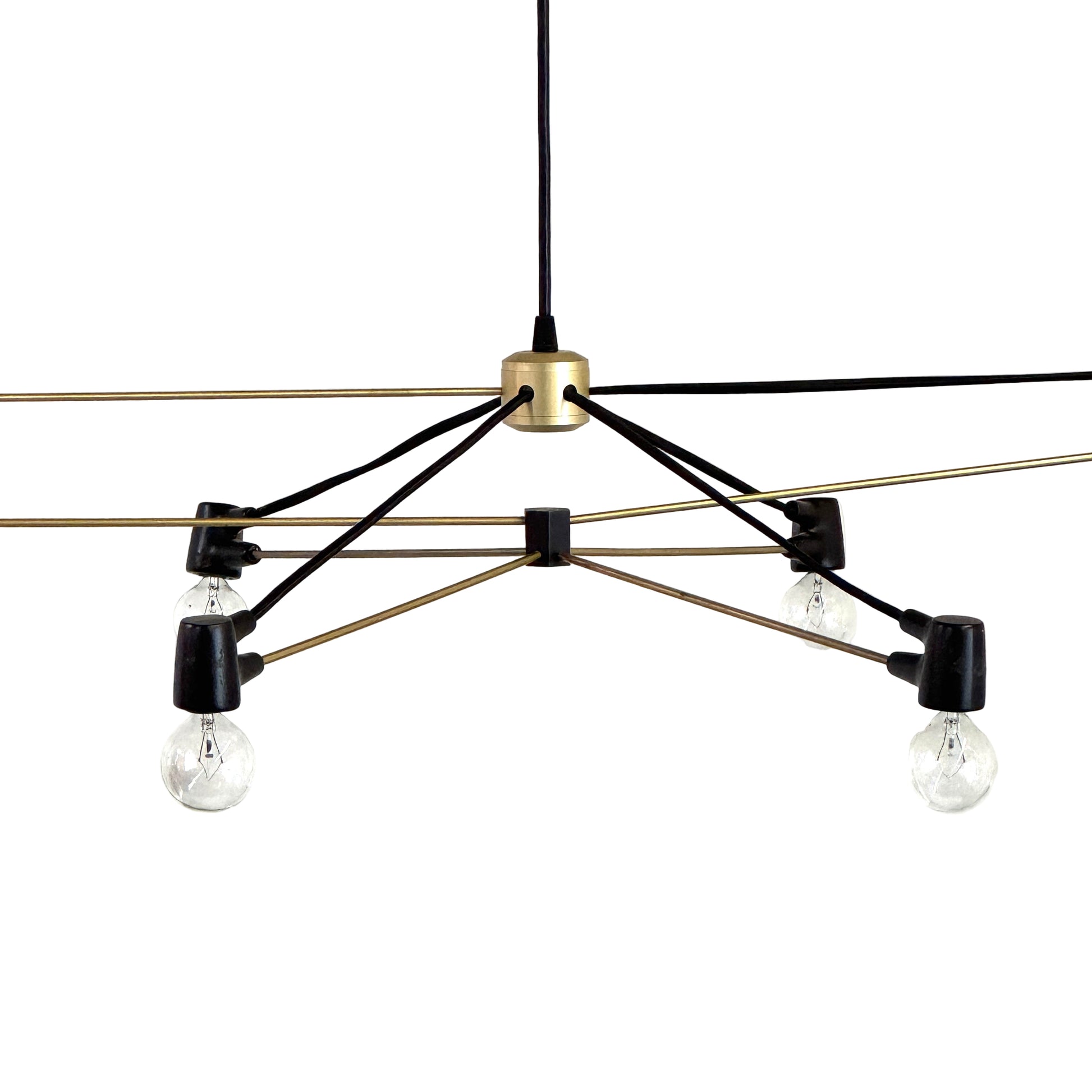 Two Ravenhill Studio Double Church Chandeliers by Ravenhill Studio, featuring exposed bulbs and modern black metal design, hang from a white industrial ceiling with visible beams, creating striking entryway lighting.