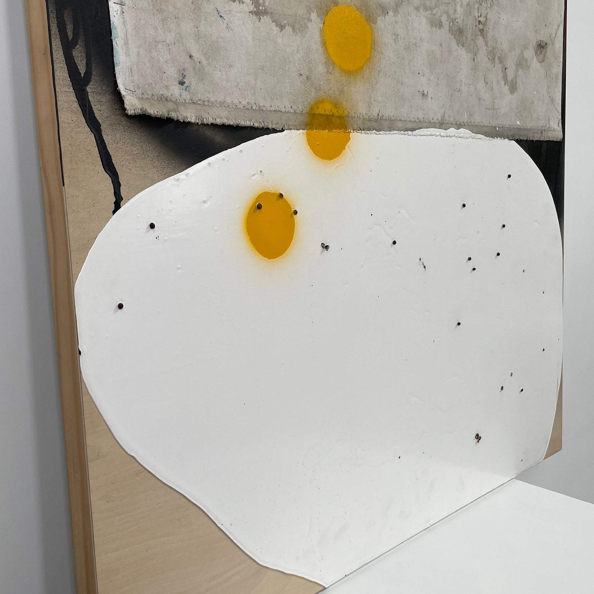 The diptych "Before We Met" by Allison Caesar displays a masterful mixed media technique: the left panel features intricately detailed gray, white, and yellow circles, while the right panel offers dynamic textures as yellow paint interacts with torn paper on a textured surface.