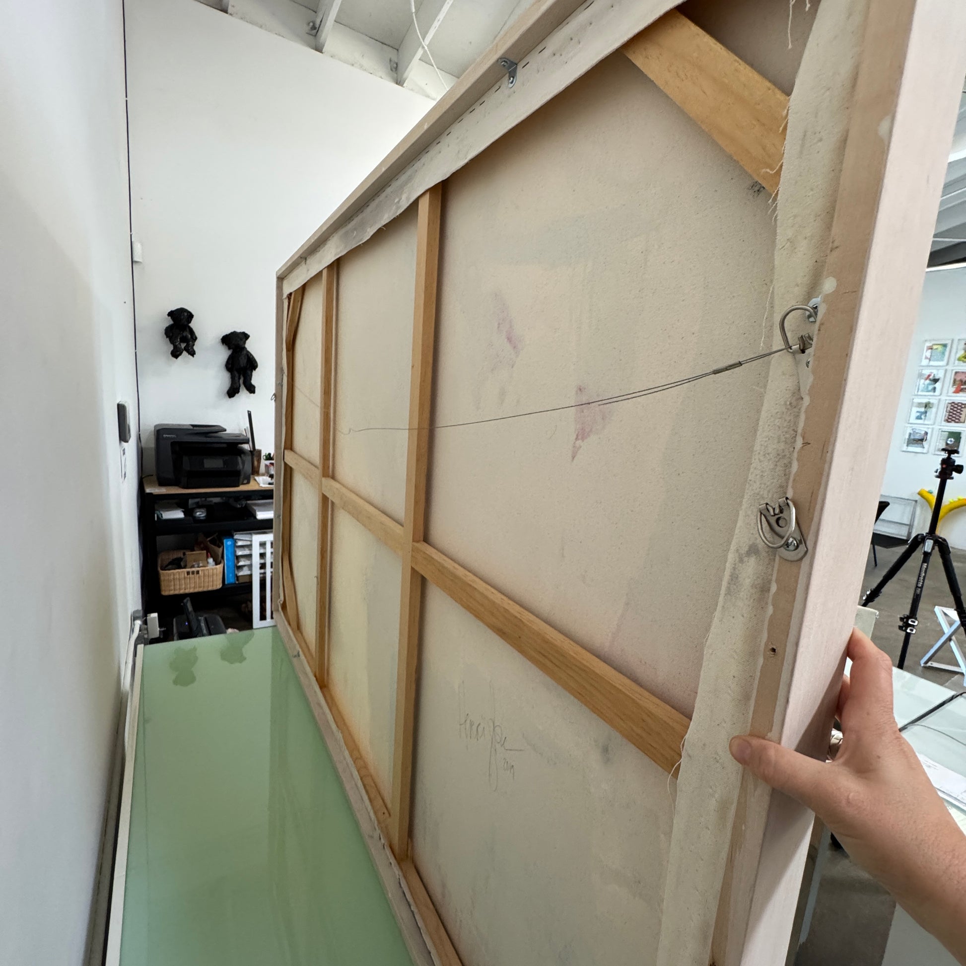 Painting: by Melissa Harrington from Artist showcases textured brushstrokes, a subtle human figure, blocks of dark green and black, with splashes of red and blue on a primarily white and beige background.