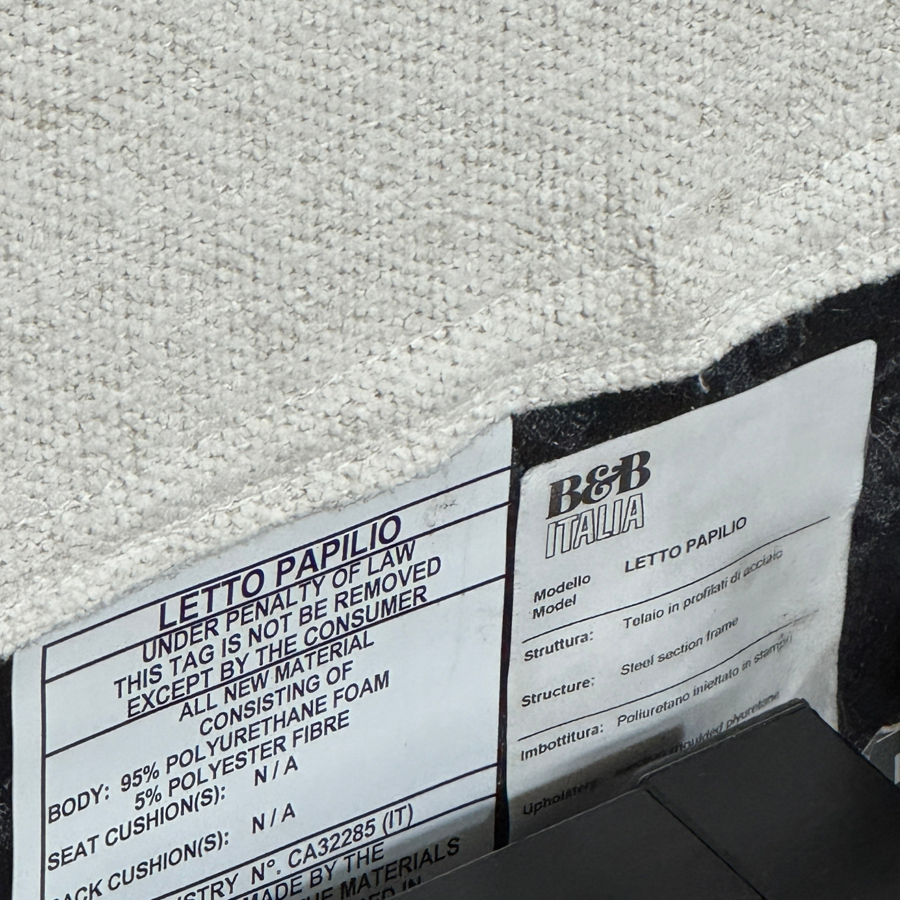 The B&B Italia Papilio King Bed by B&B Italia features a modern upholstered frame, cushioned headboard, and exposed wooden slats—ideal for contemporary bedrooms. Shown on a white background.