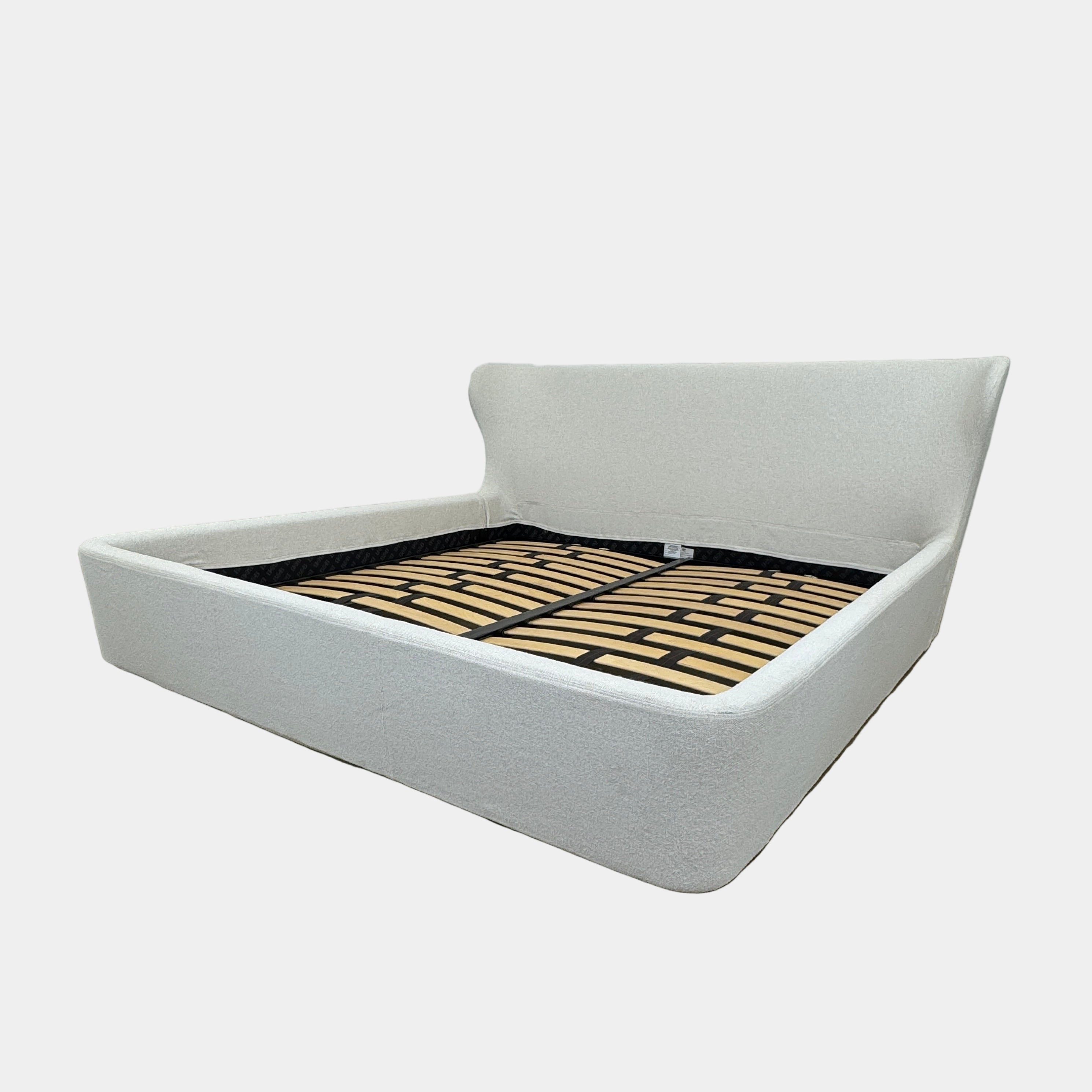 The B&B Italia Papilio King Bed by B&B Italia features a modern upholstered frame, cushioned headboard, and exposed wooden slats—ideal for contemporary bedrooms. Shown on a white background.