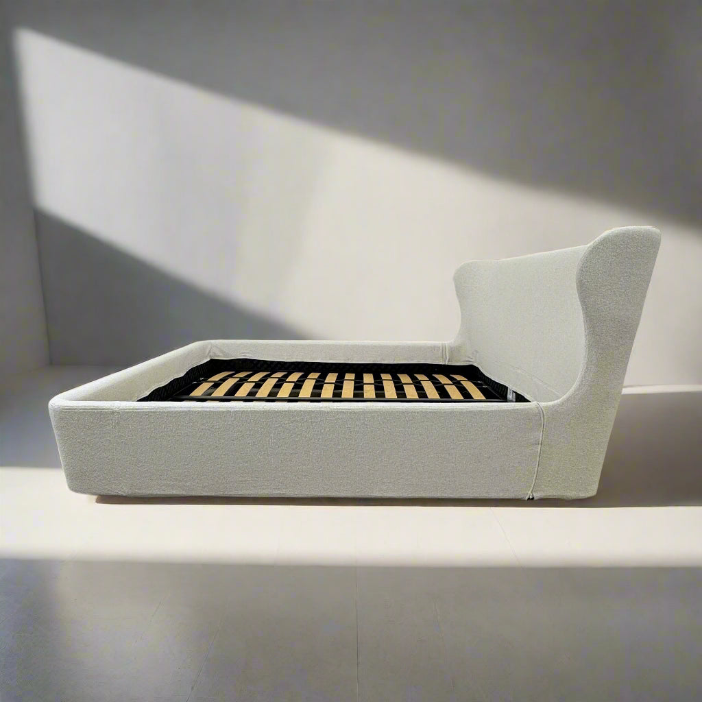 The B&B Italia Papilio King Bed by B&B Italia features a modern upholstered frame, cushioned headboard, and exposed wooden slats—ideal for contemporary bedrooms. Shown on a white background.