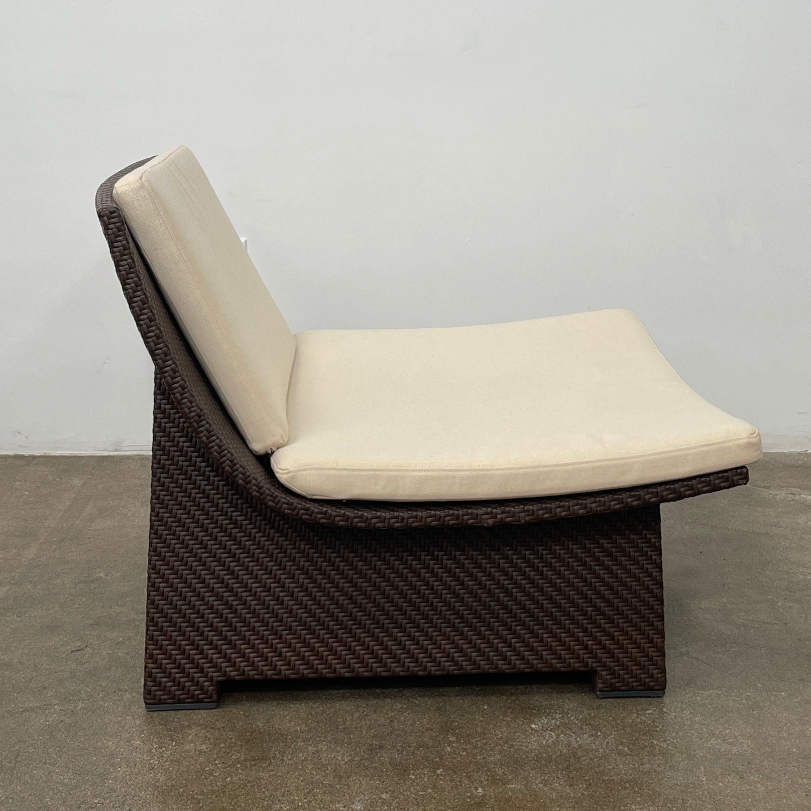 The Dedon Spa Outdoor Lounge Chairs set features two cream-cushioned seats made with proprietary fiber, beautifully displayed side by side against a simple white backdrop.