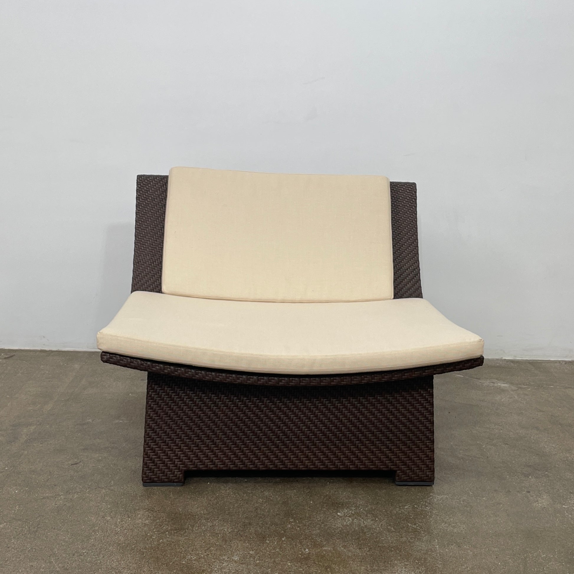 The Dedon Spa Outdoor Lounge Chairs set features two cream-cushioned seats made with proprietary fiber, beautifully displayed side by side against a simple white backdrop.