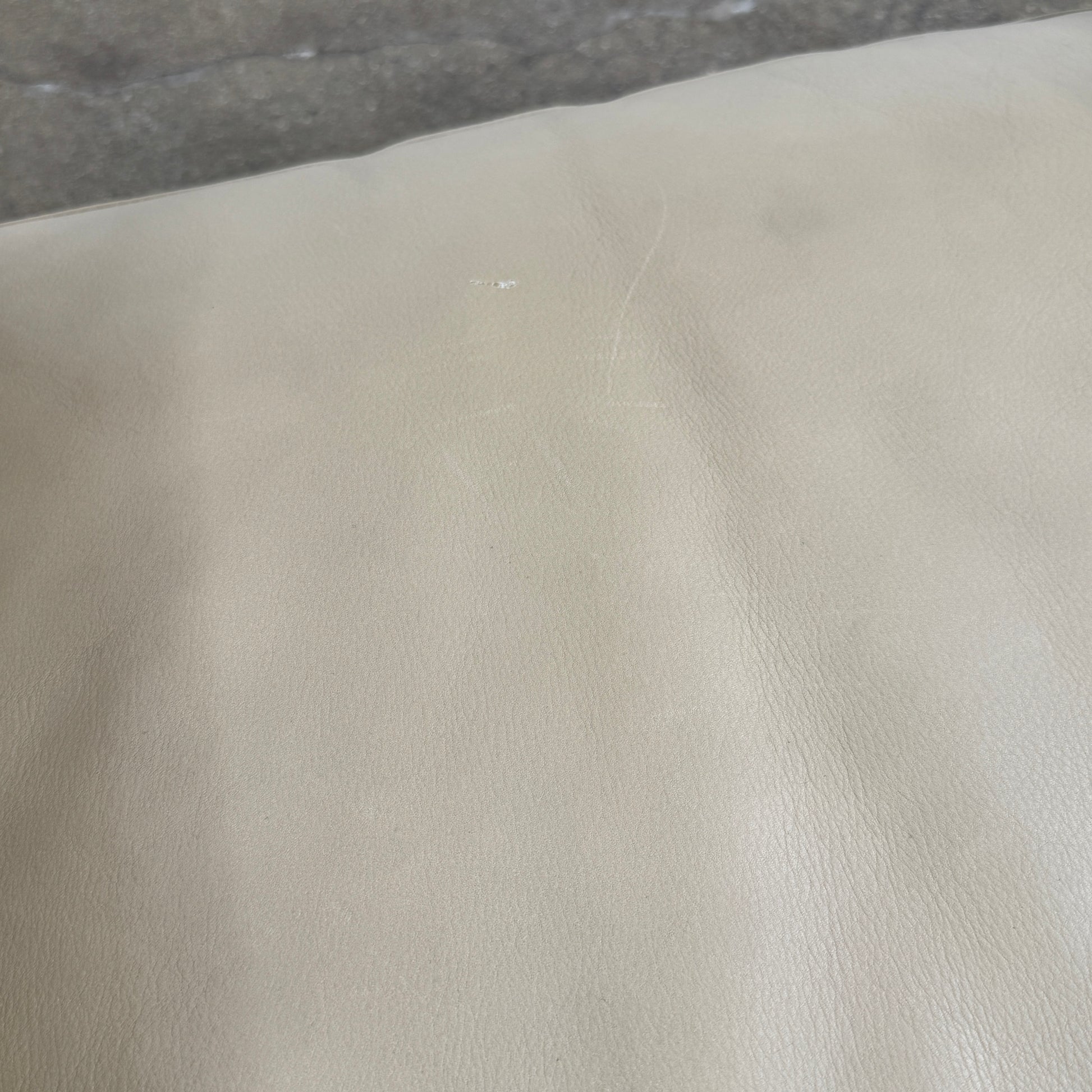 The Maxalto Musa Armchair features a light brown top-grain leather seat and backrest, gray oak wooden frame, and square armrests, set against a plain white background.