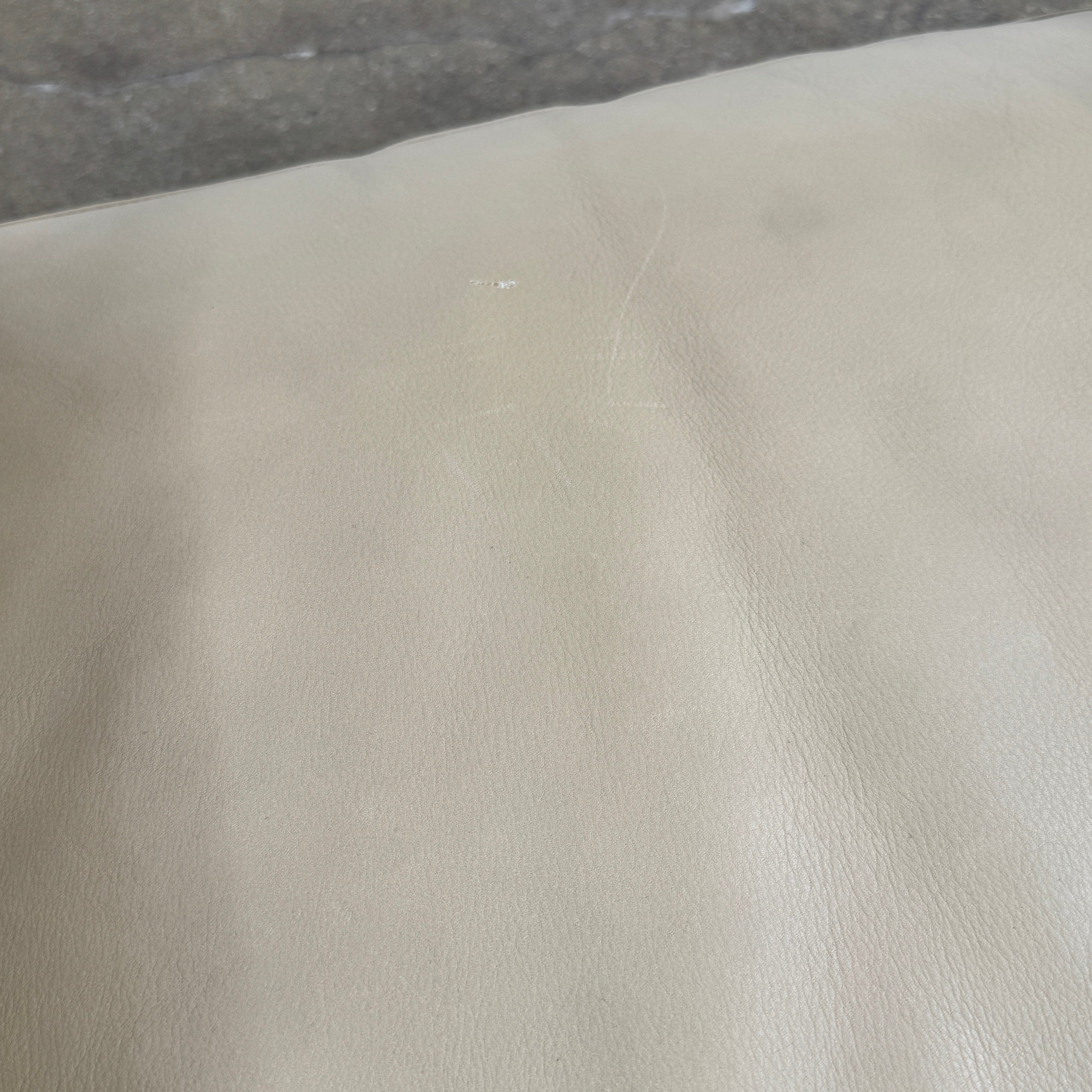 The Maxalto Musa Armchair features a light brown top-grain leather seat and backrest, gray oak wooden frame, and square armrests, set against a plain white background.