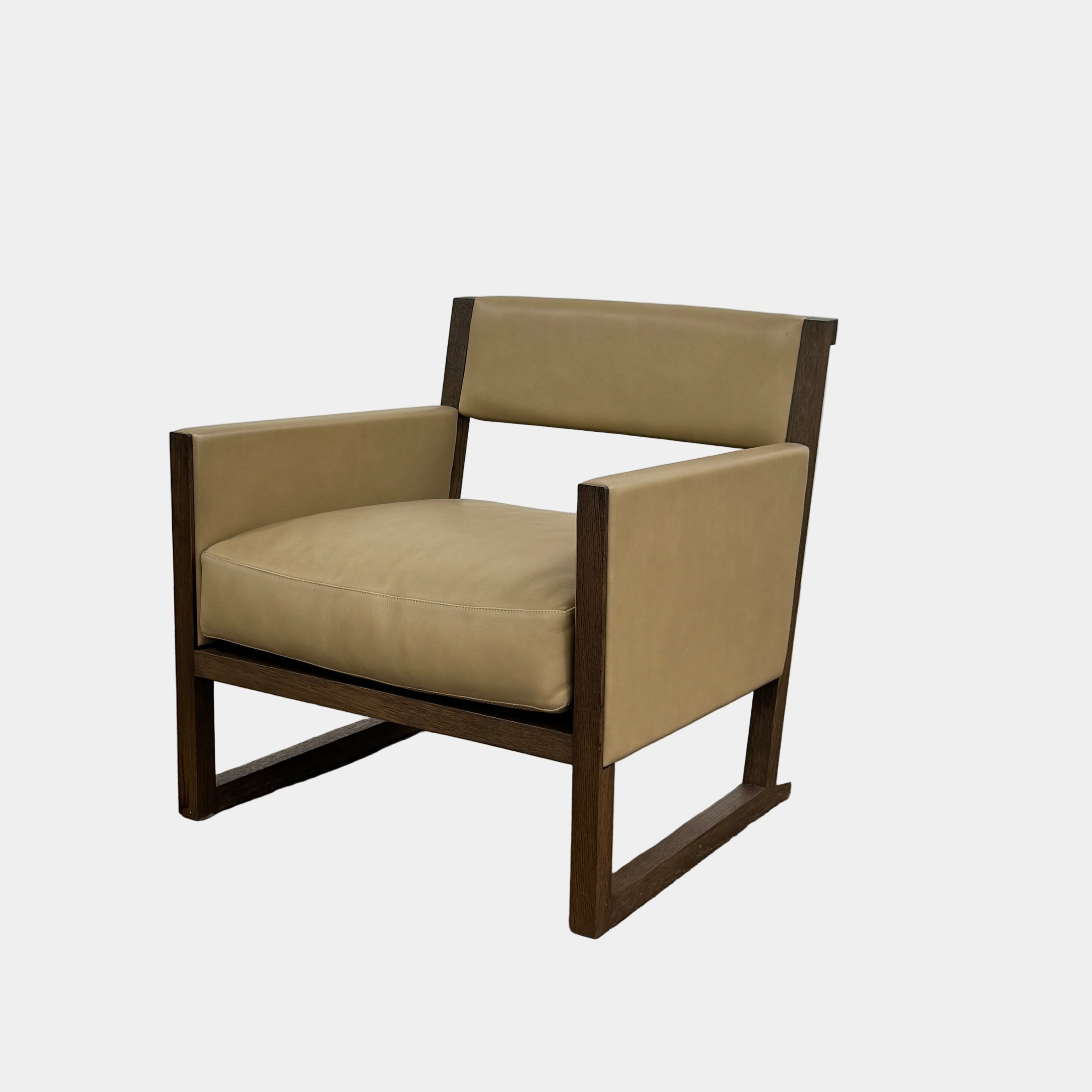 The Maxalto Musa Armchair features a light brown top-grain leather seat and backrest, gray oak wooden frame, and square armrests, set against a plain white background.