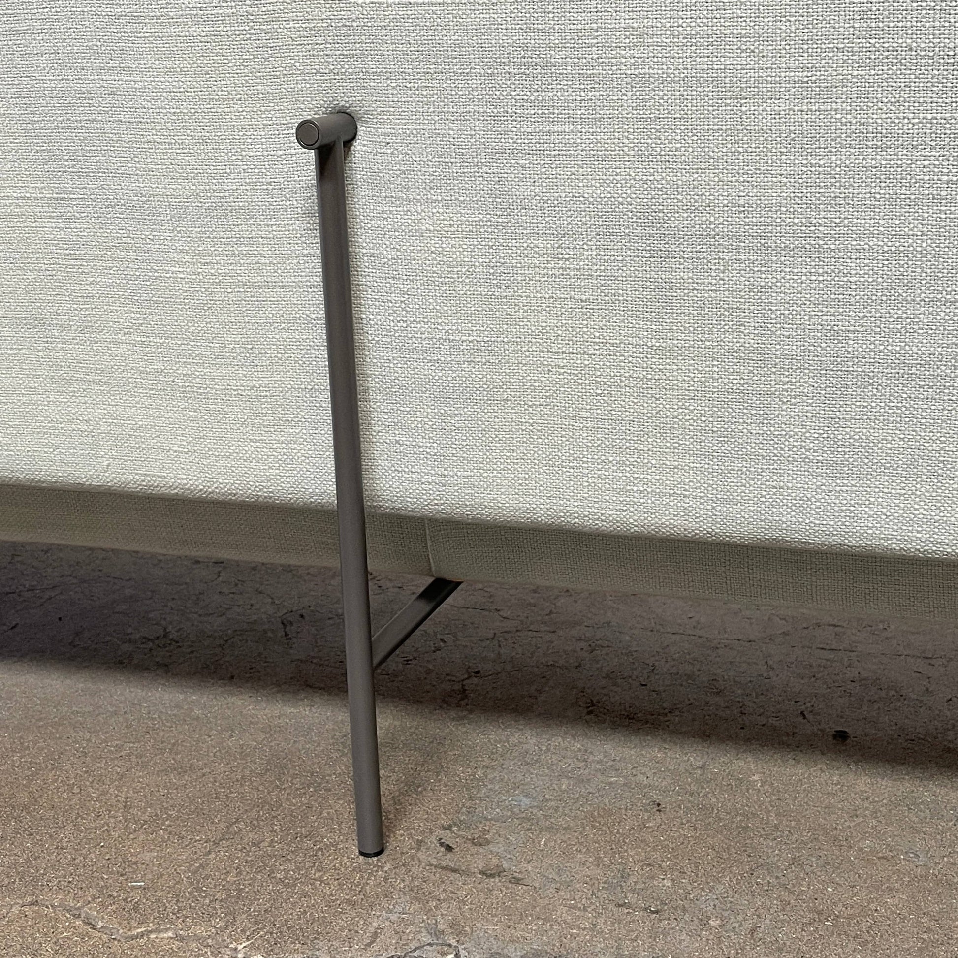 The Delcourt Collection Hug Sofa from the Delcourt Collection offers customizable fabric choices, including a light blue option, and is supported by sleek black legs.