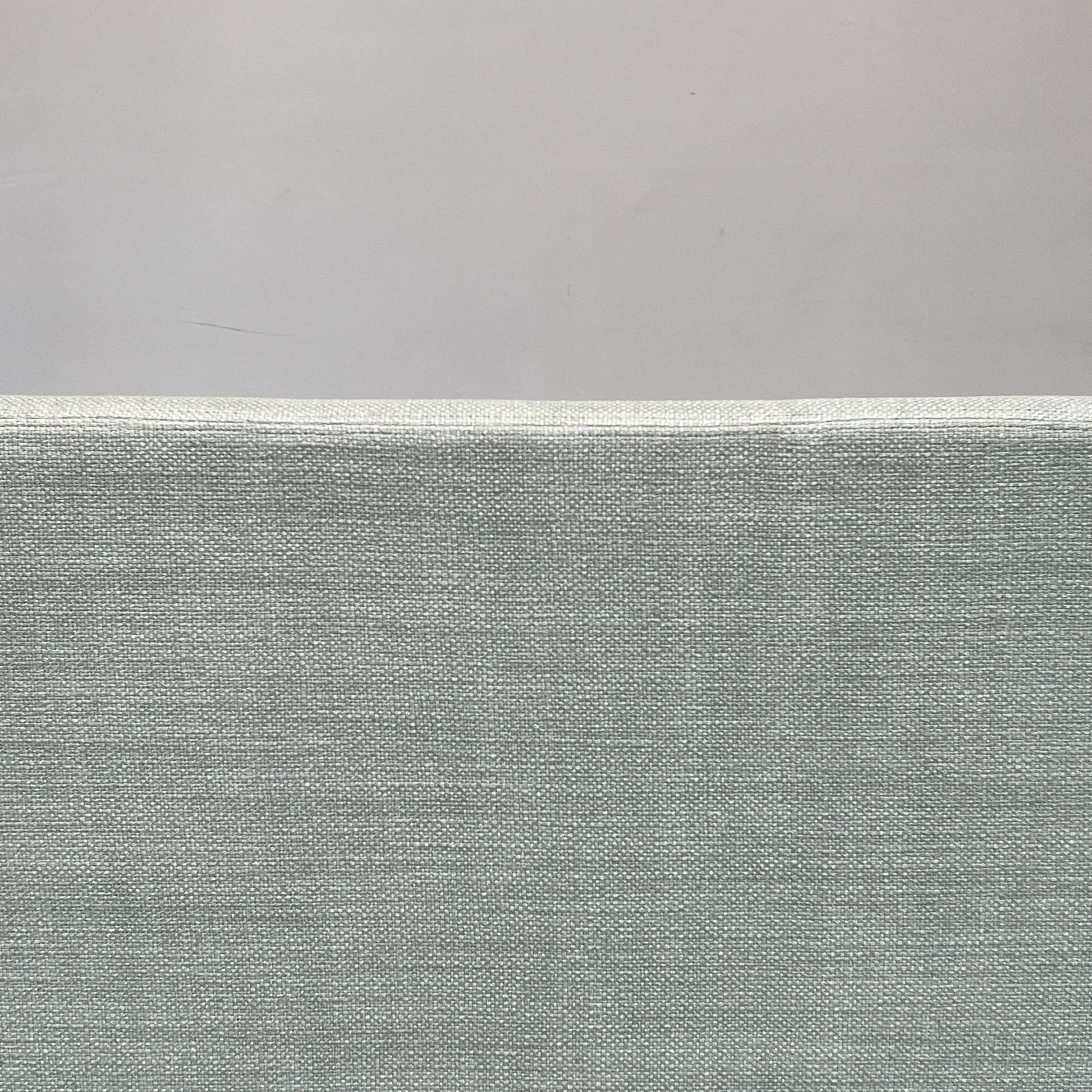 The Delcourt Collection Hug Sofa from the Delcourt Collection offers customizable fabric choices, including a light blue option, and is supported by sleek black legs.