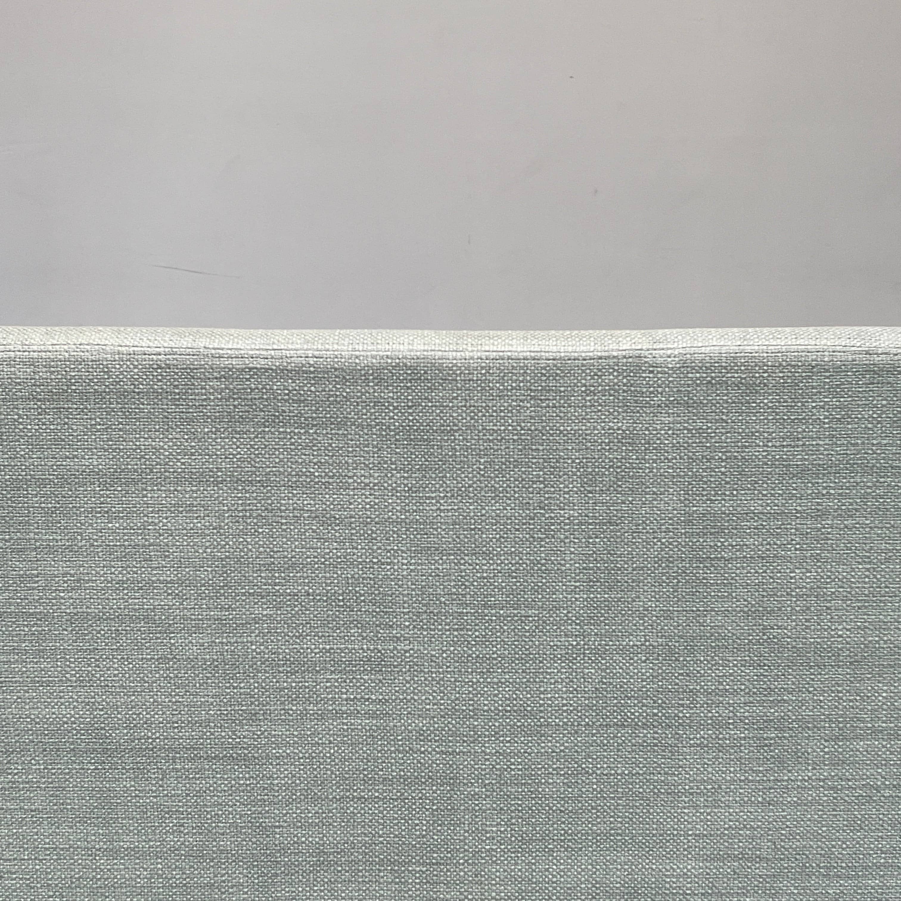 The Delcourt Collection Hug Sofa from the Delcourt Collection offers customizable fabric choices, including a light blue option, and is supported by sleek black legs.