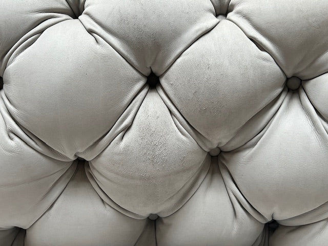 A white Baxter Chester Moon Sofa with a tufted back.